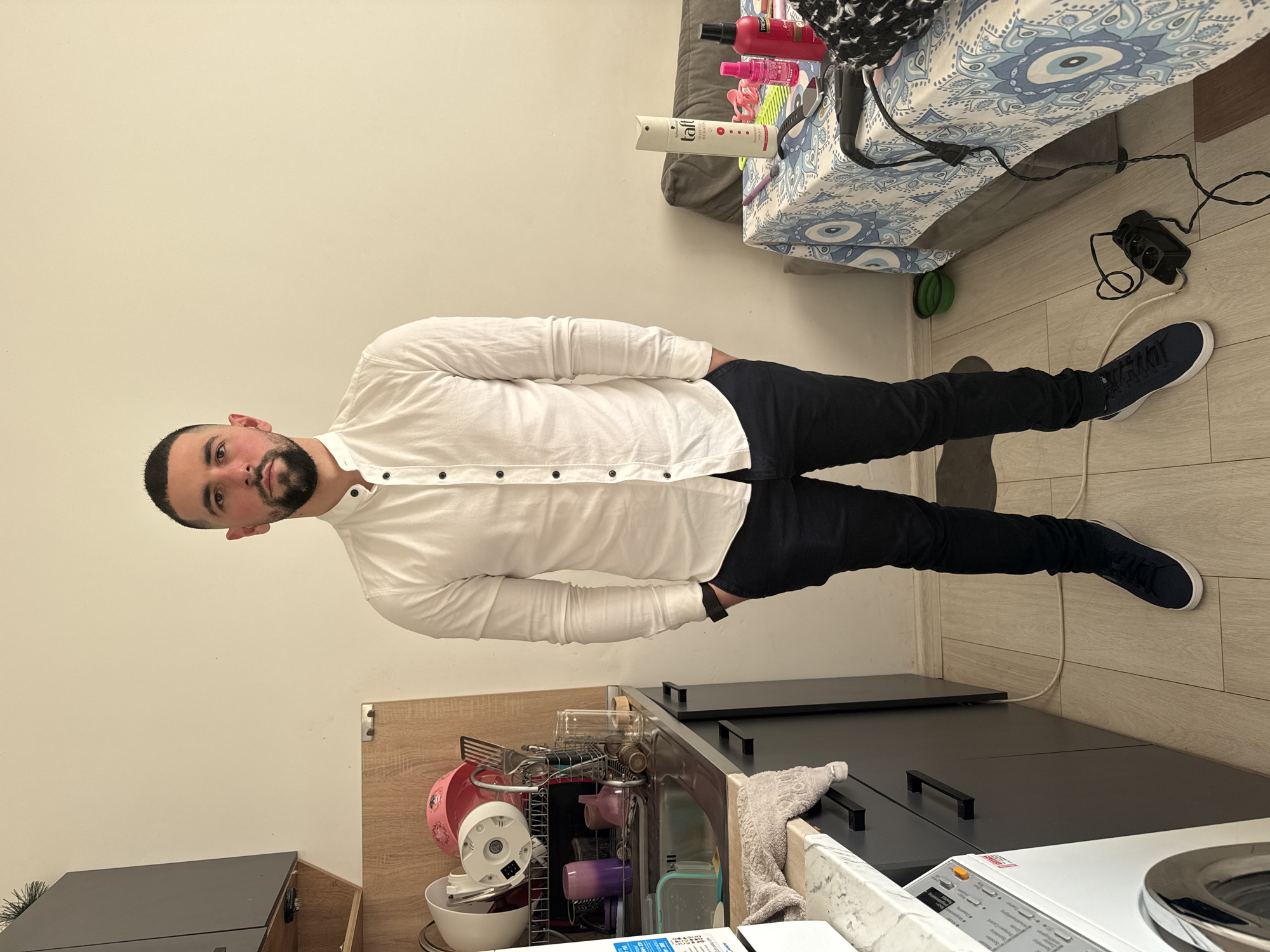 Man in white shirt observed standing indoors in Sofia