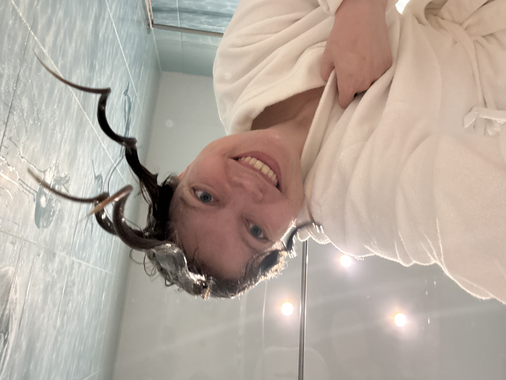 Morning beauty routine documented in Izhevsk bathroom with cat