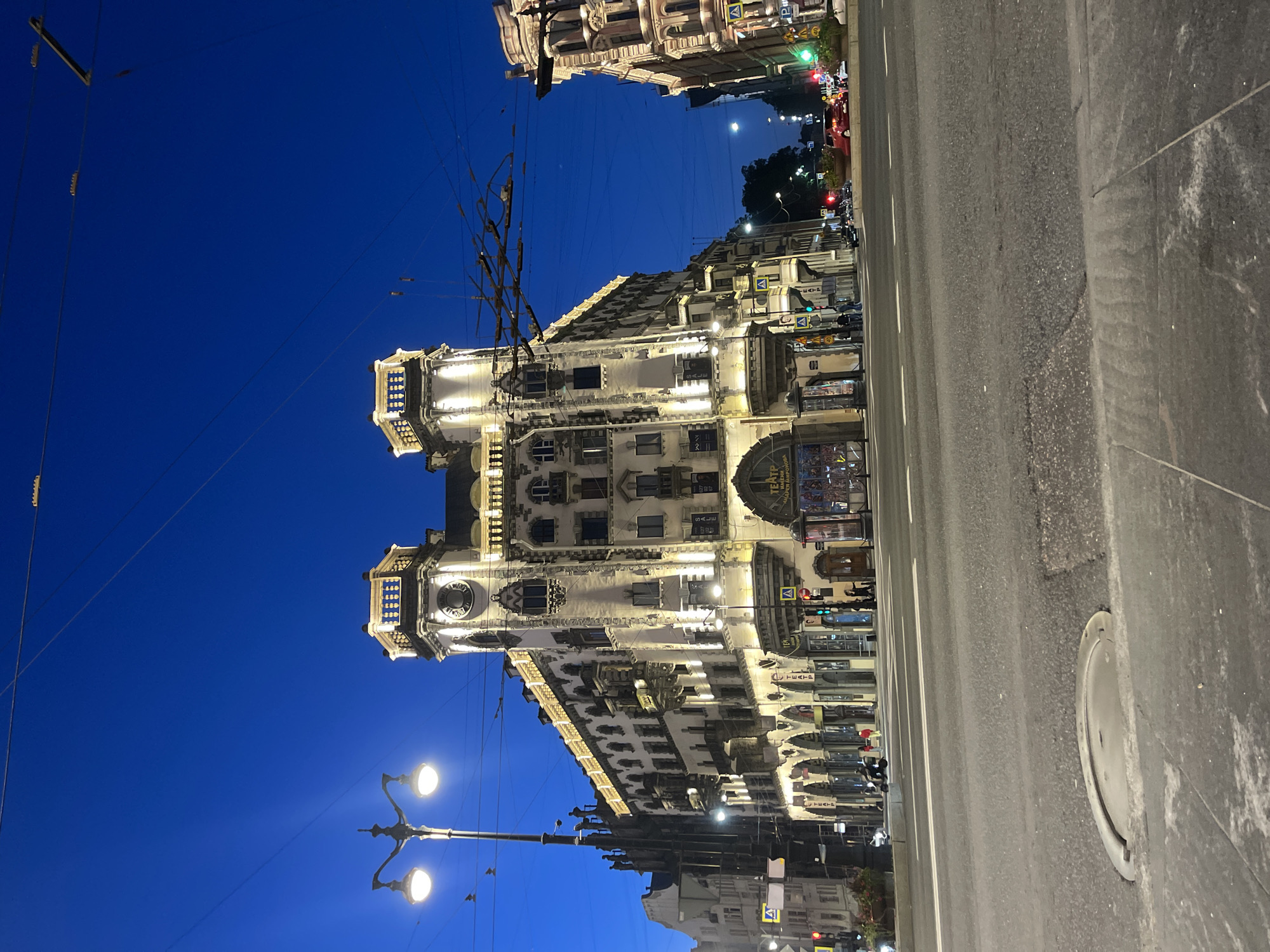 Ornate illuminated building glows at dusk in Saint Petersburg