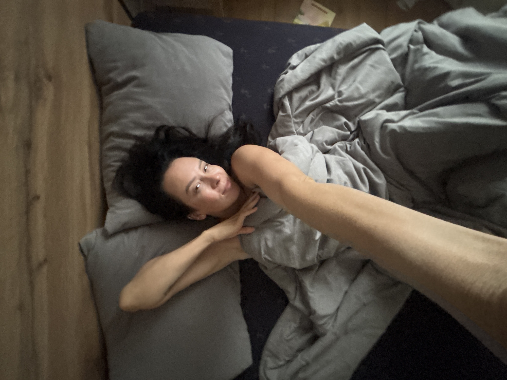 Woman resting in bed photographed in Chaikovsky, Russia