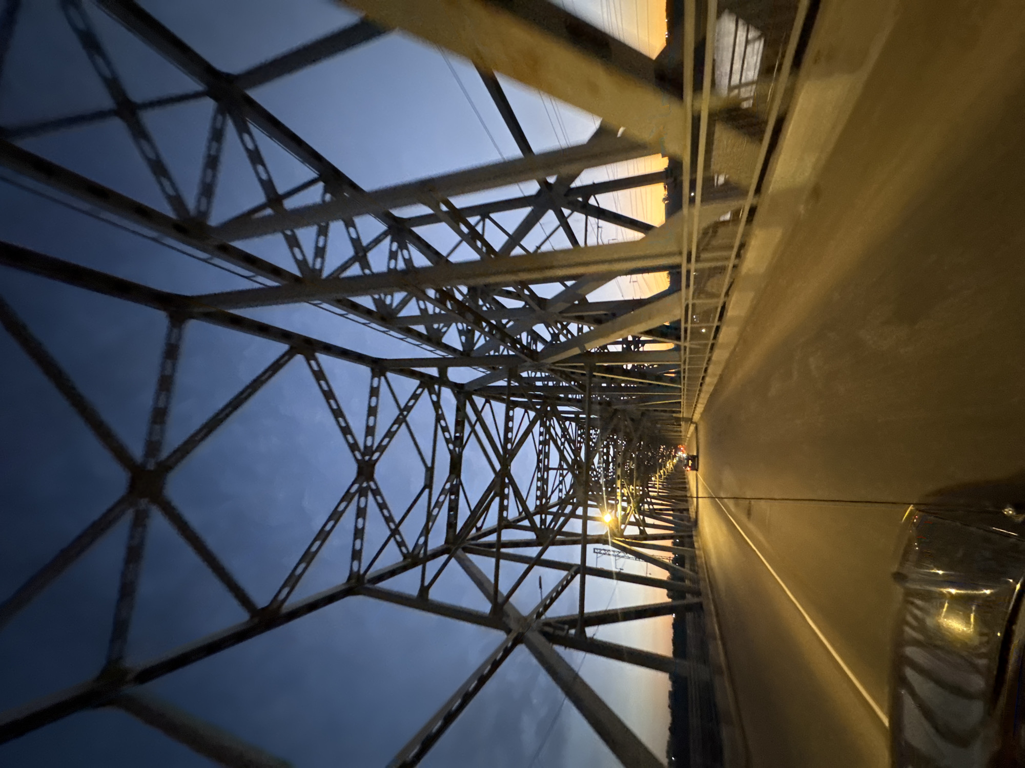 Steel truss bridge in Krasnoyarsk, inside and underneath at dusk