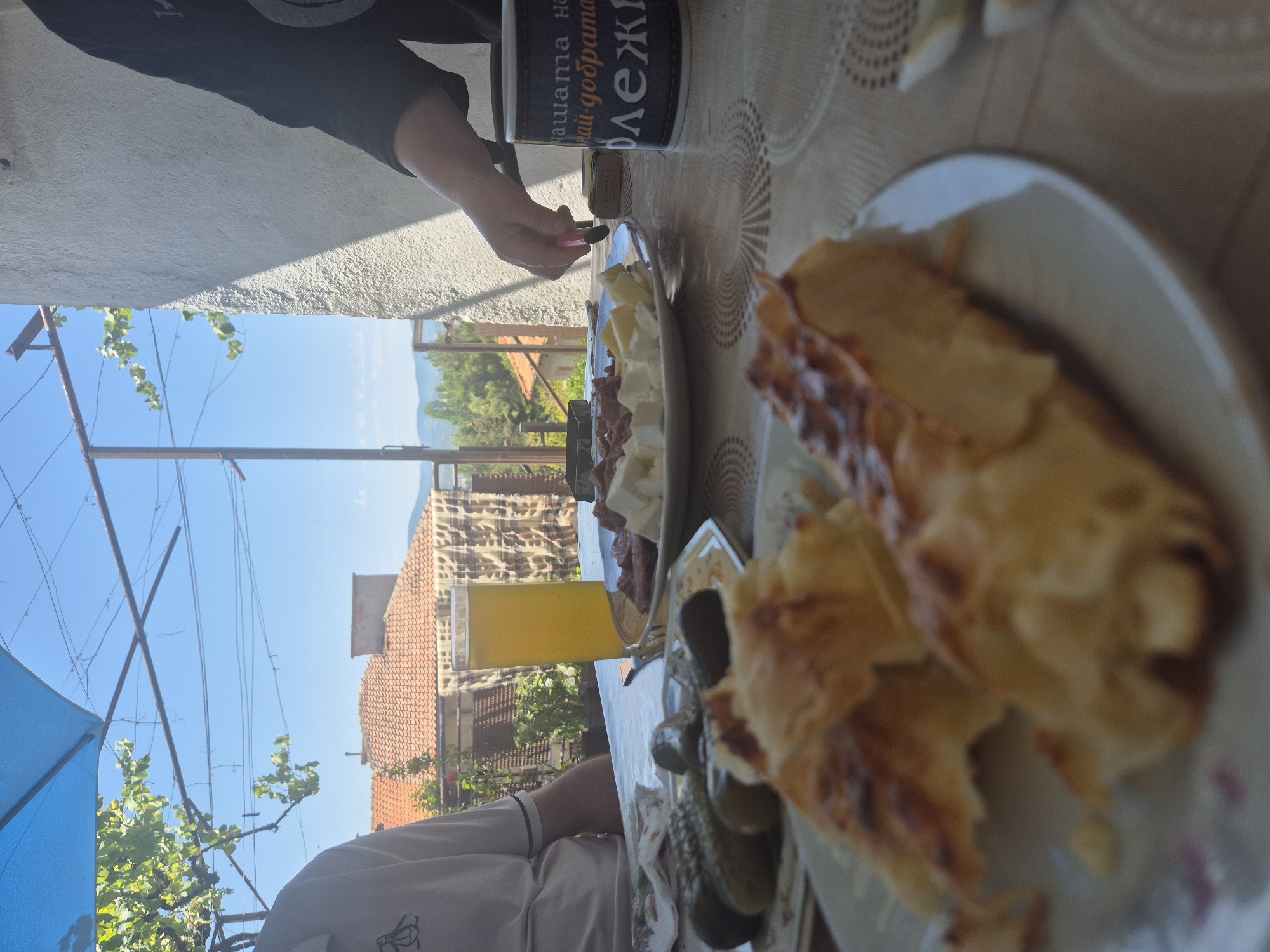 Lazy outdoor brunch with food, a cat, and good company