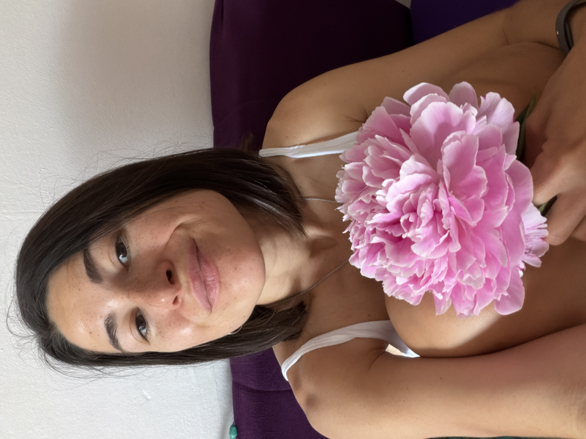 Woman and child pose with pink peonies in Budva