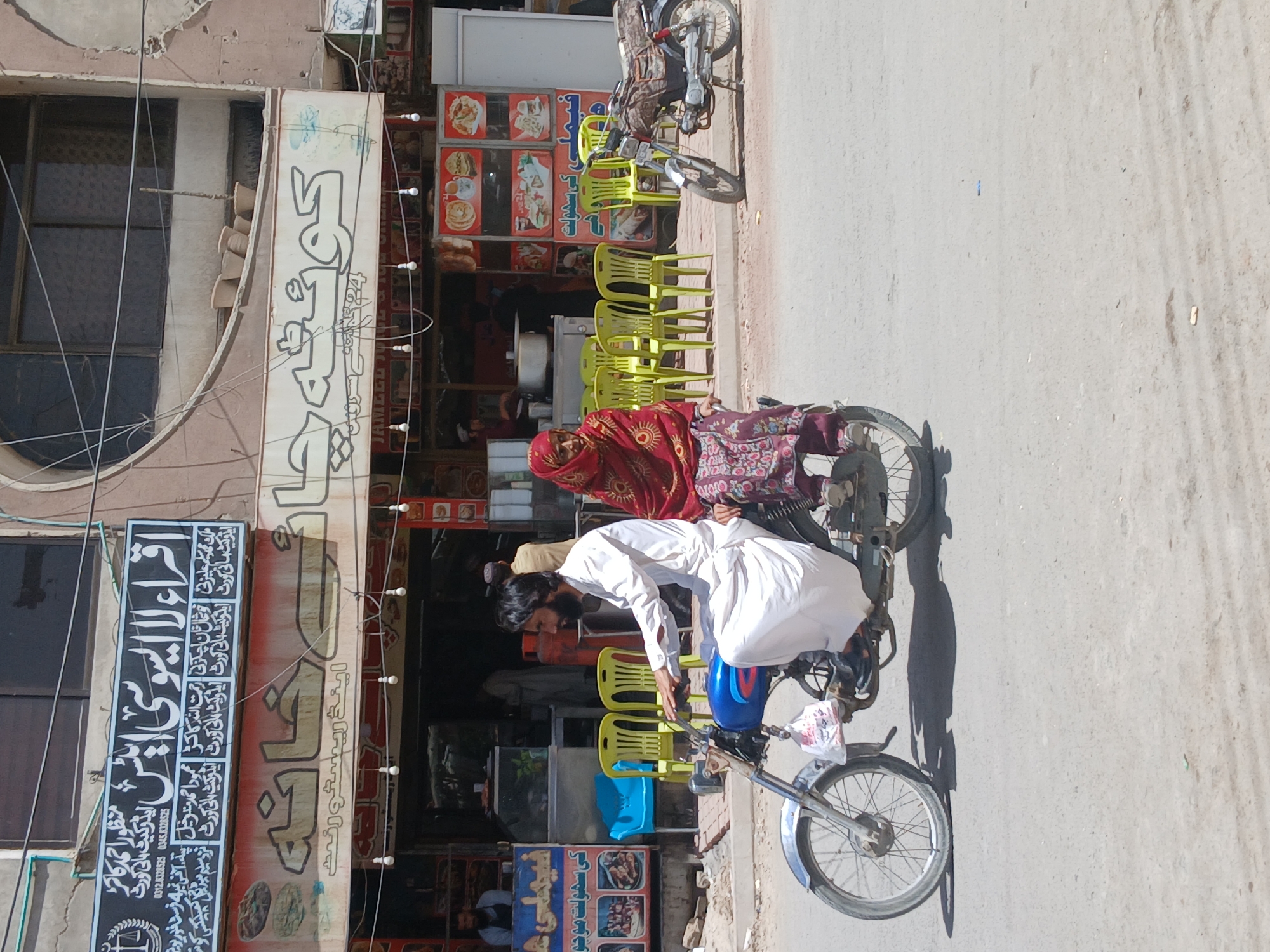 Man repairs motorcycle tire on Quetta street