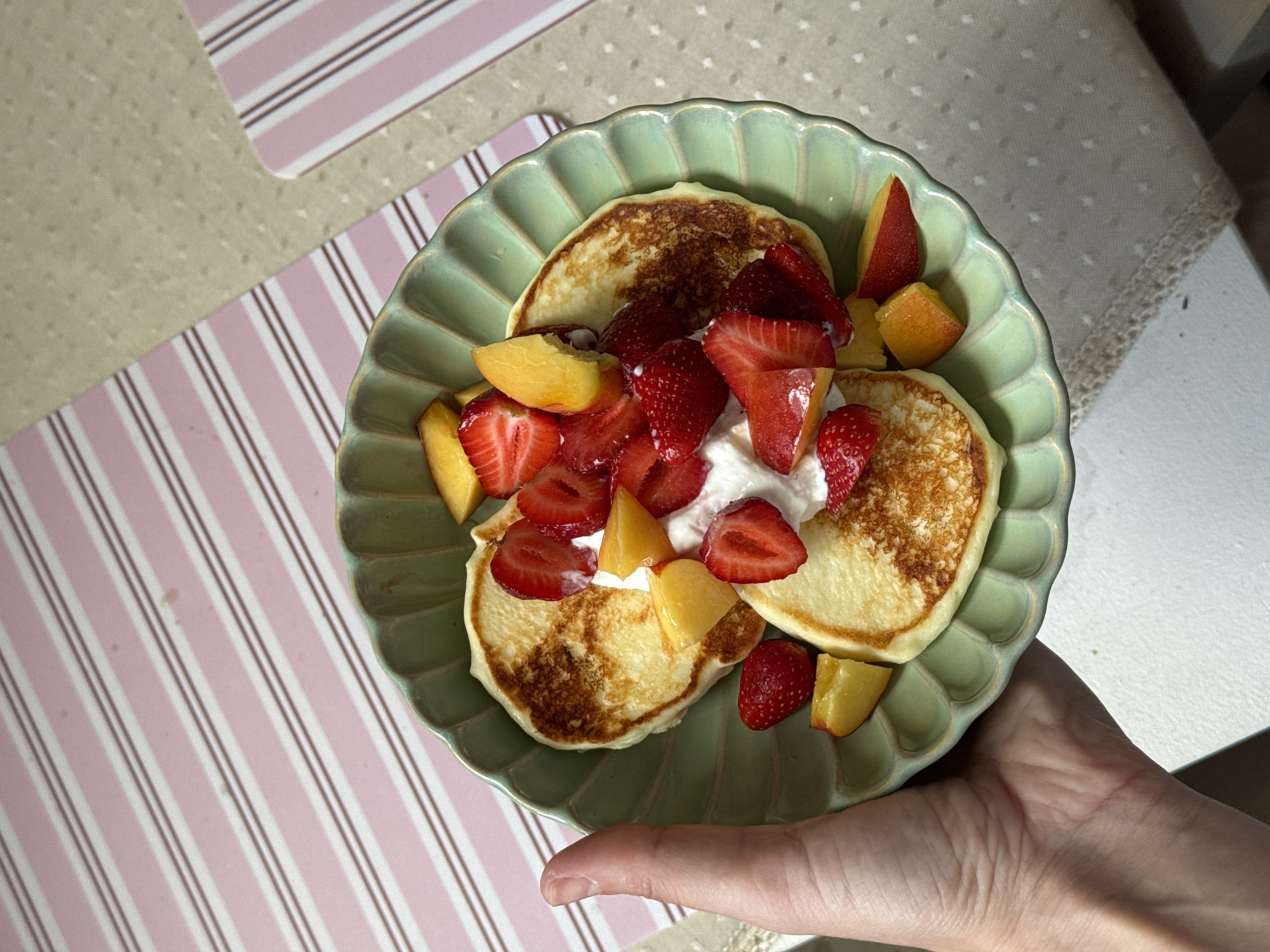 Pancake breakfast with fruit garnish observed in Krasnoyarsk