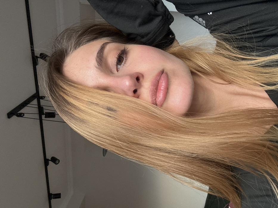 Woman takes multiple selfies in residential setting
