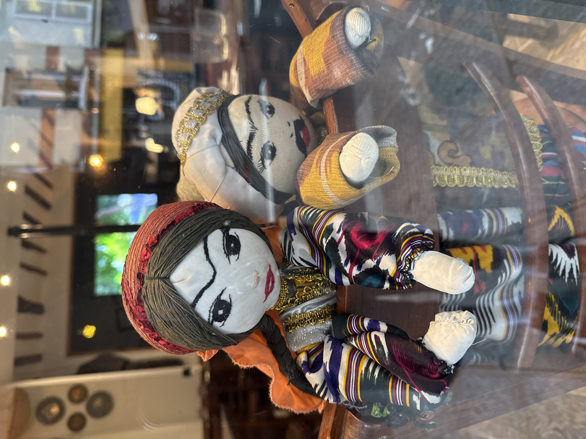 Traditional dolls displayed behind glass in Paris showcase
