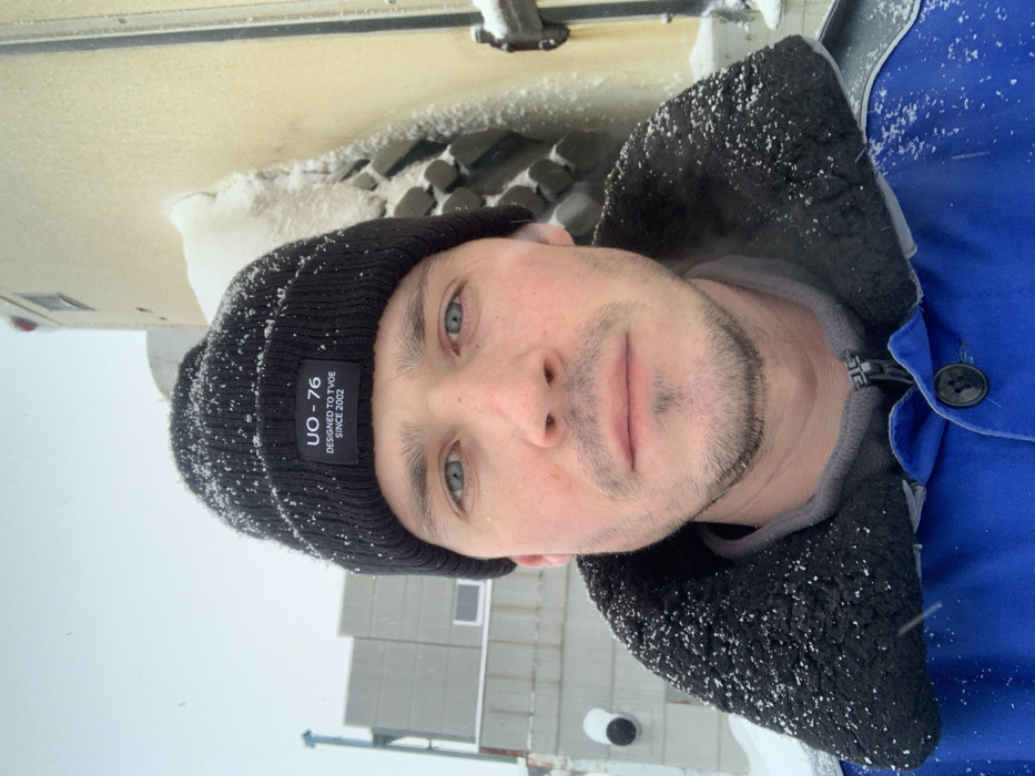 Man in tagged beanie spotted during snowfall in Kliuchi