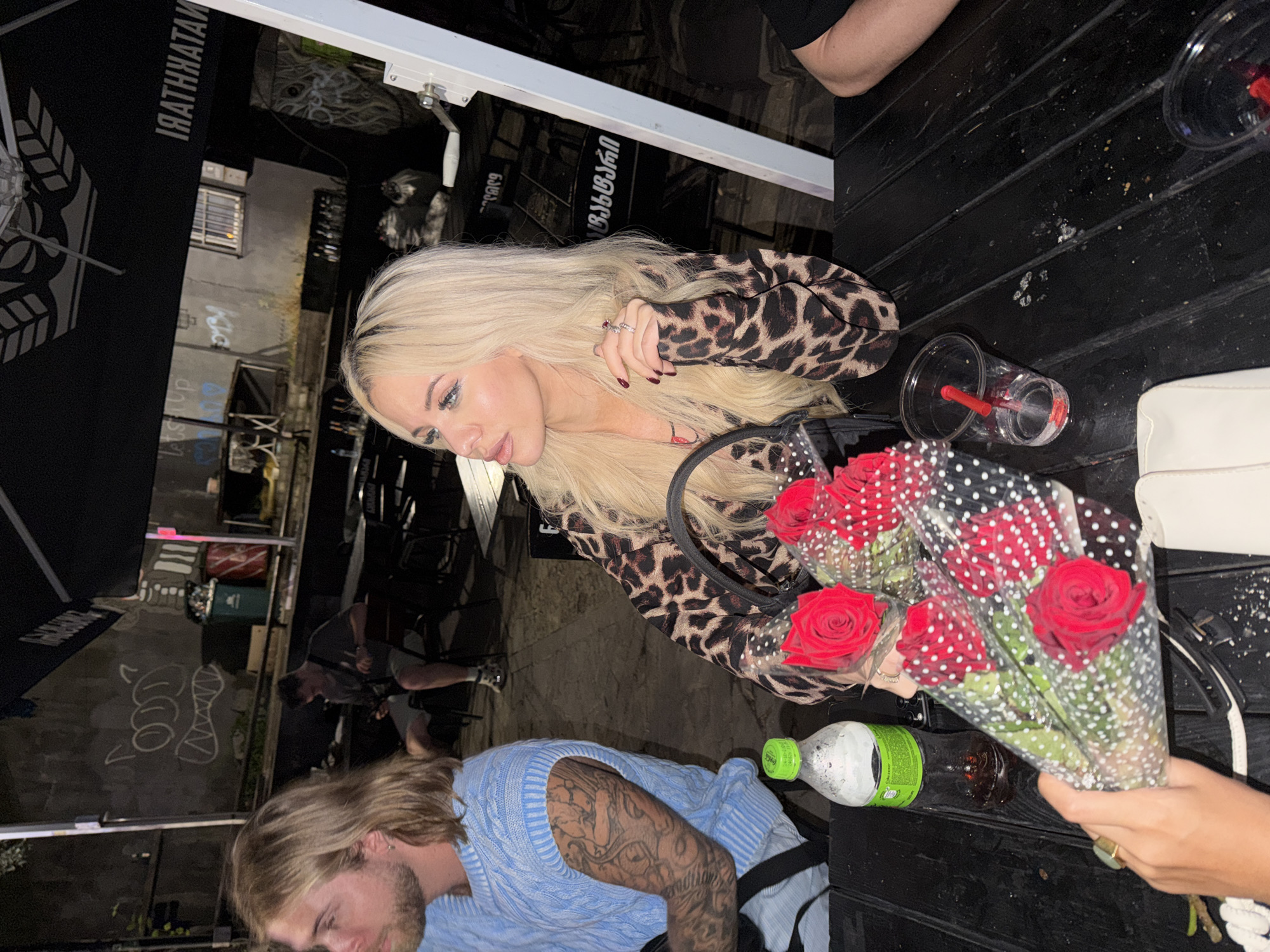 Late-night drinks and red roses at a Tbilisi outdoor cafe
