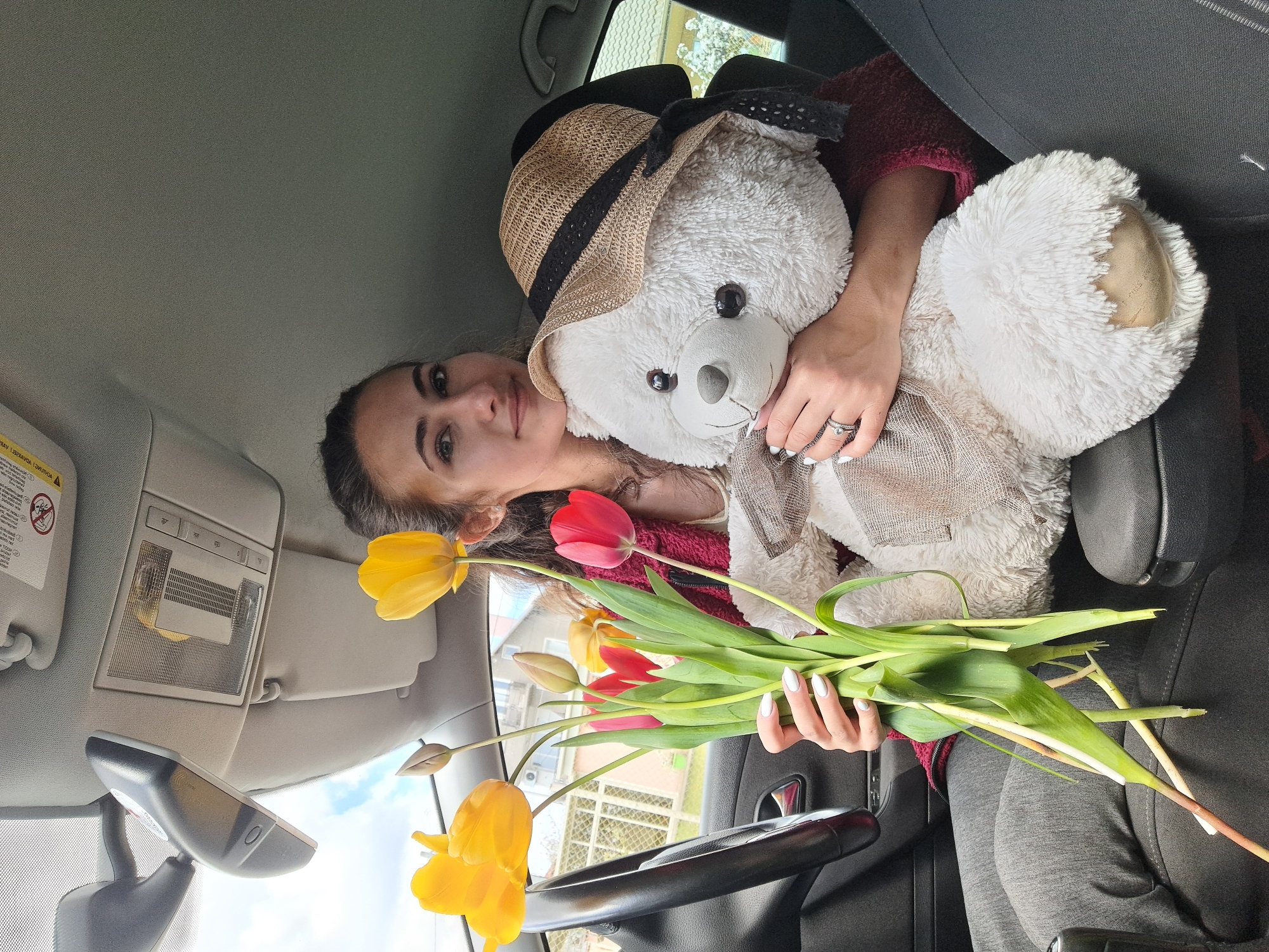 Woman with tulips and teddy bear amid spring blooms in Bulgaria