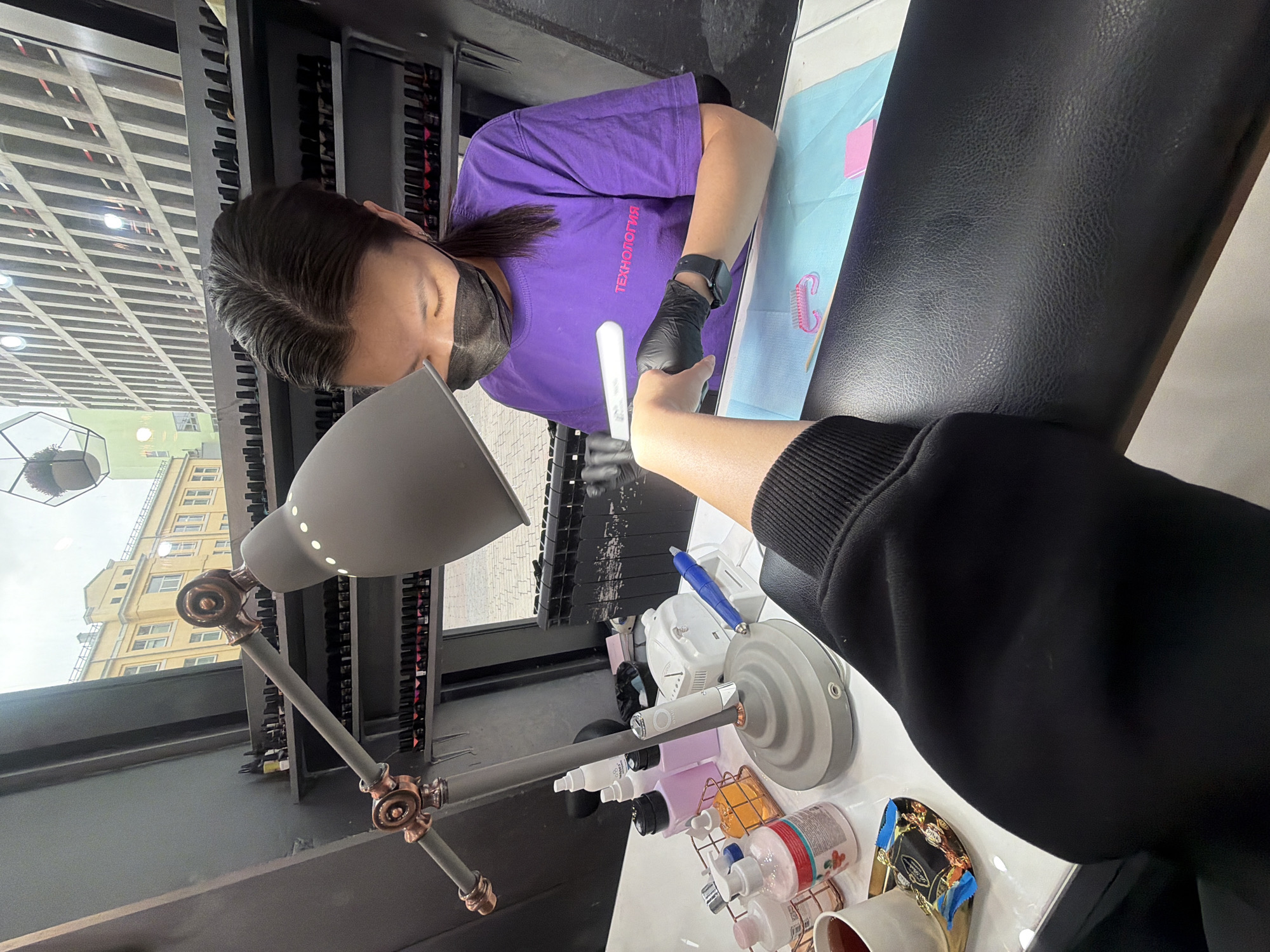 Nail technician provides manicure services in Khimki, Russia