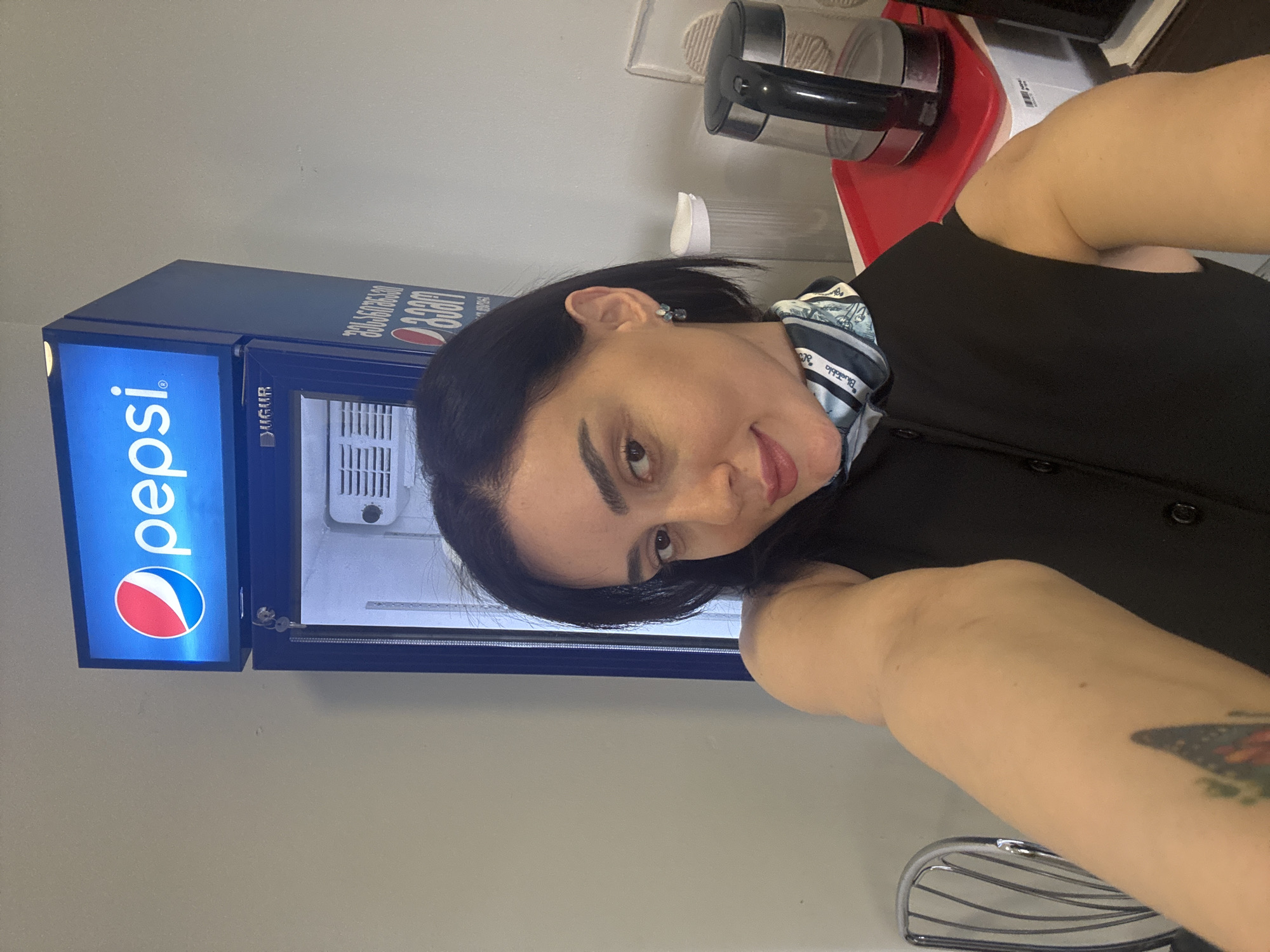 Woman takes selfies in Tbilisi kitchen with Pepsi fridge