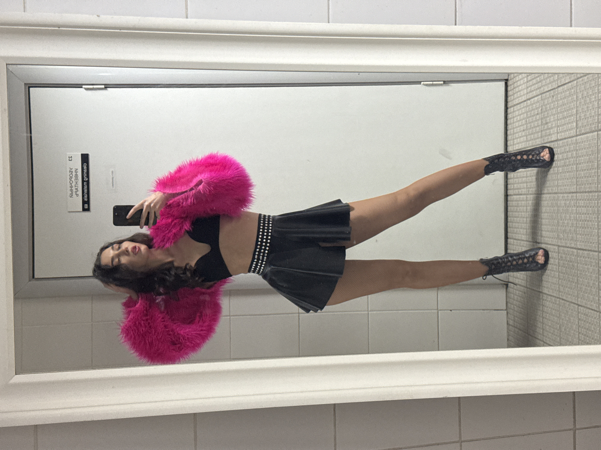 Woman takes mirror selfies in Kazan public restroom