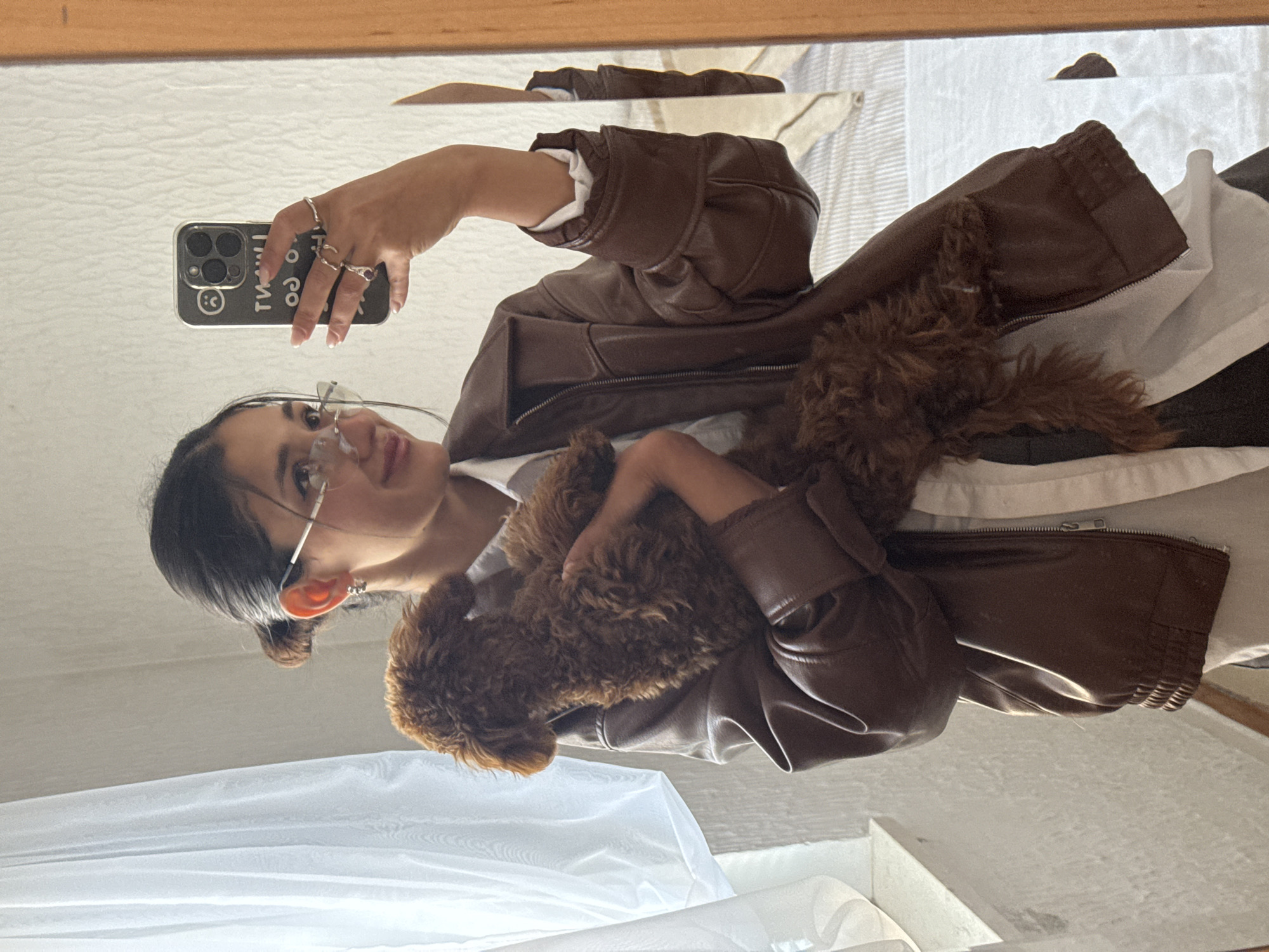 Woman takes mirror selfie with brown poodle in Sutomore