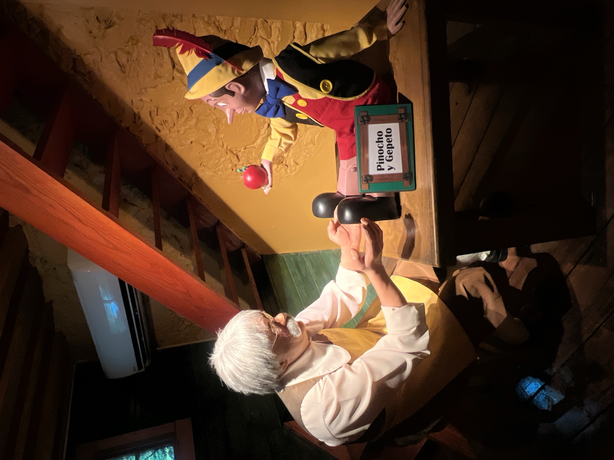 Visitors document wax museum displays and entertainment exhibits