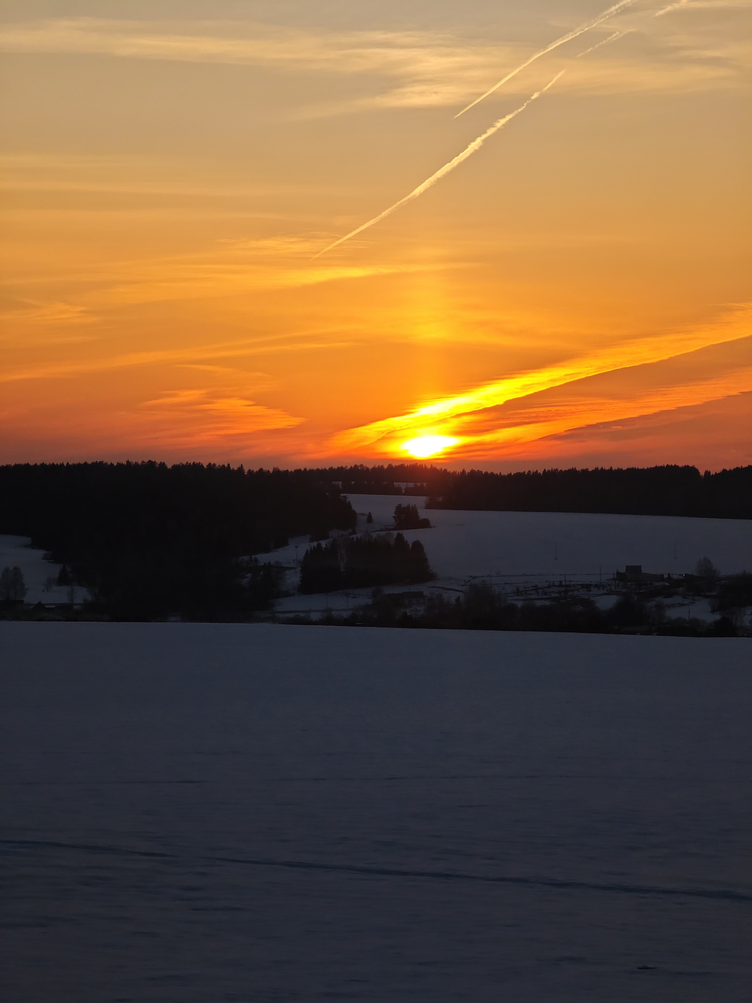 Winter sunset illuminates sky over Большая Уса, Russia