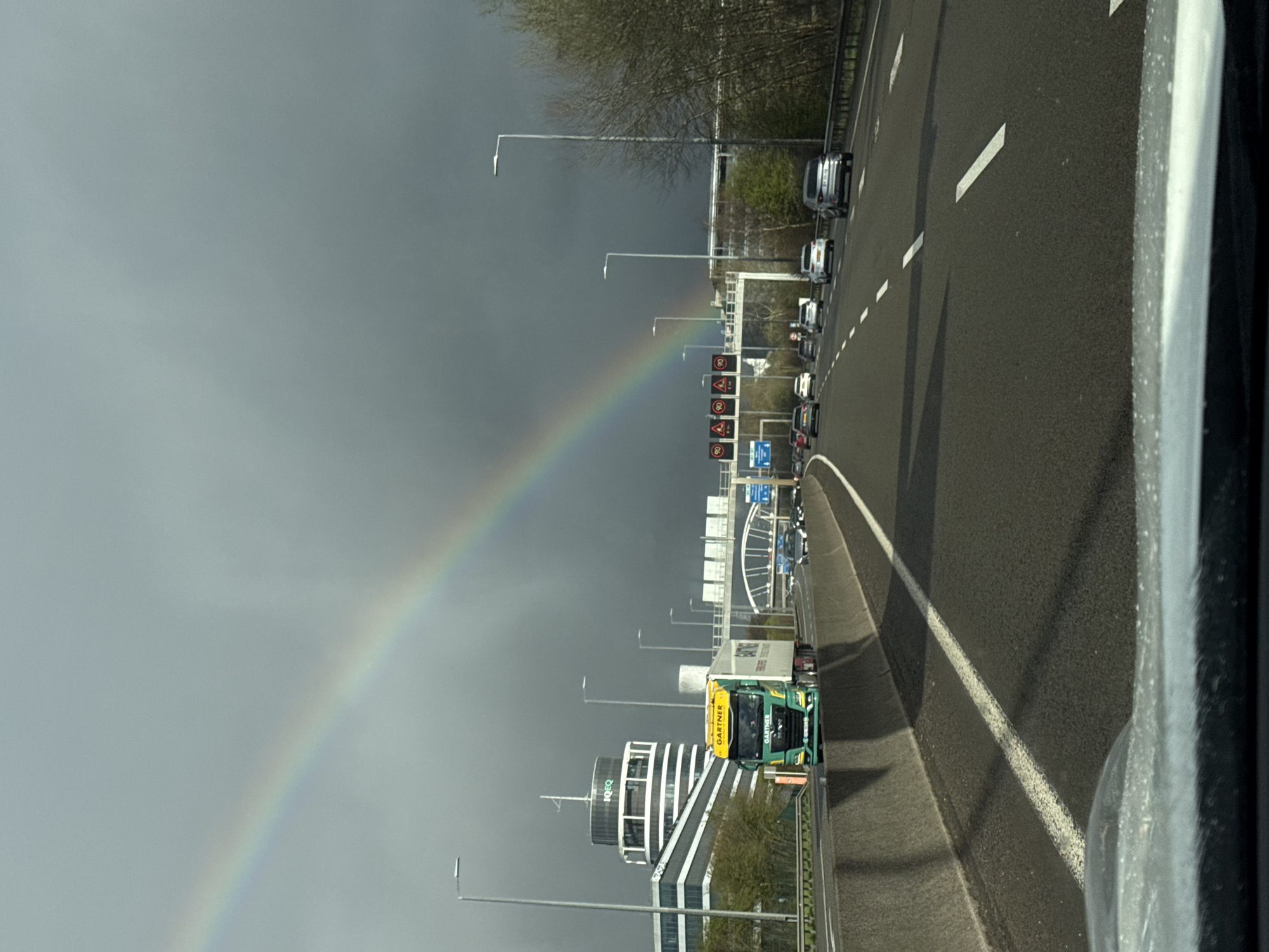 Rainbow spans sky above Luxembourg highway