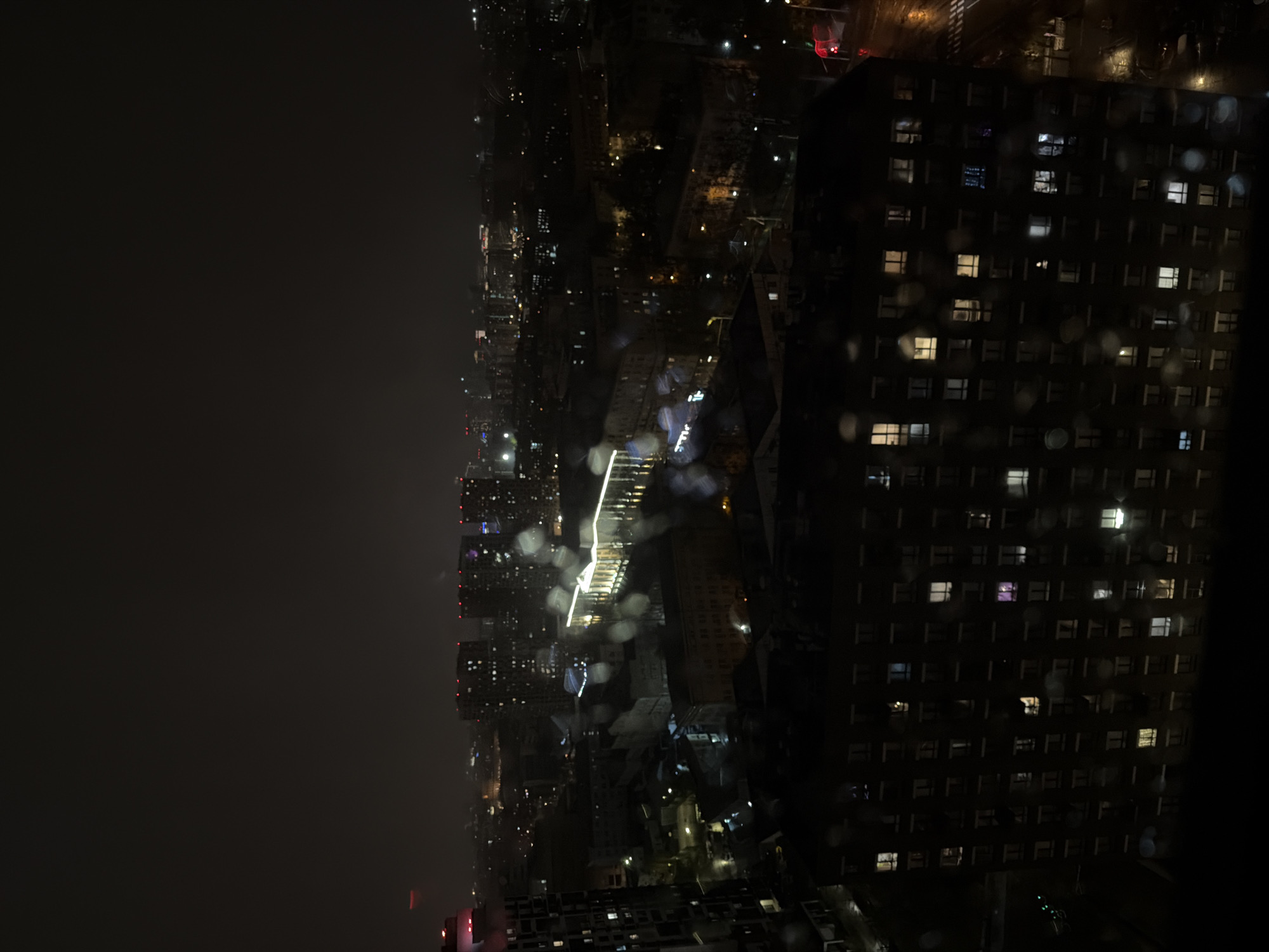 Rainy night cityscape captured from aerial view