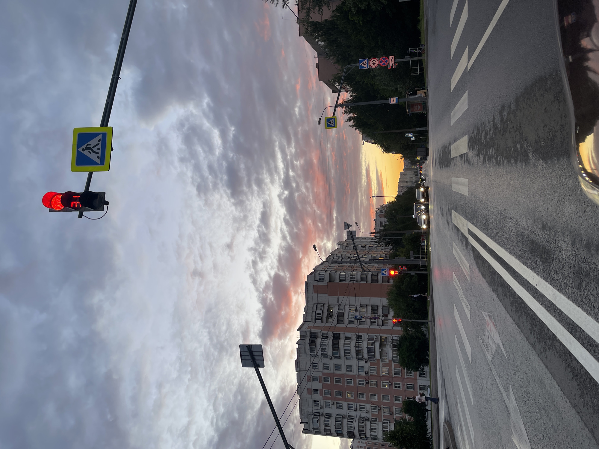 Moscow intersection glows under a dramatic June sunset sky