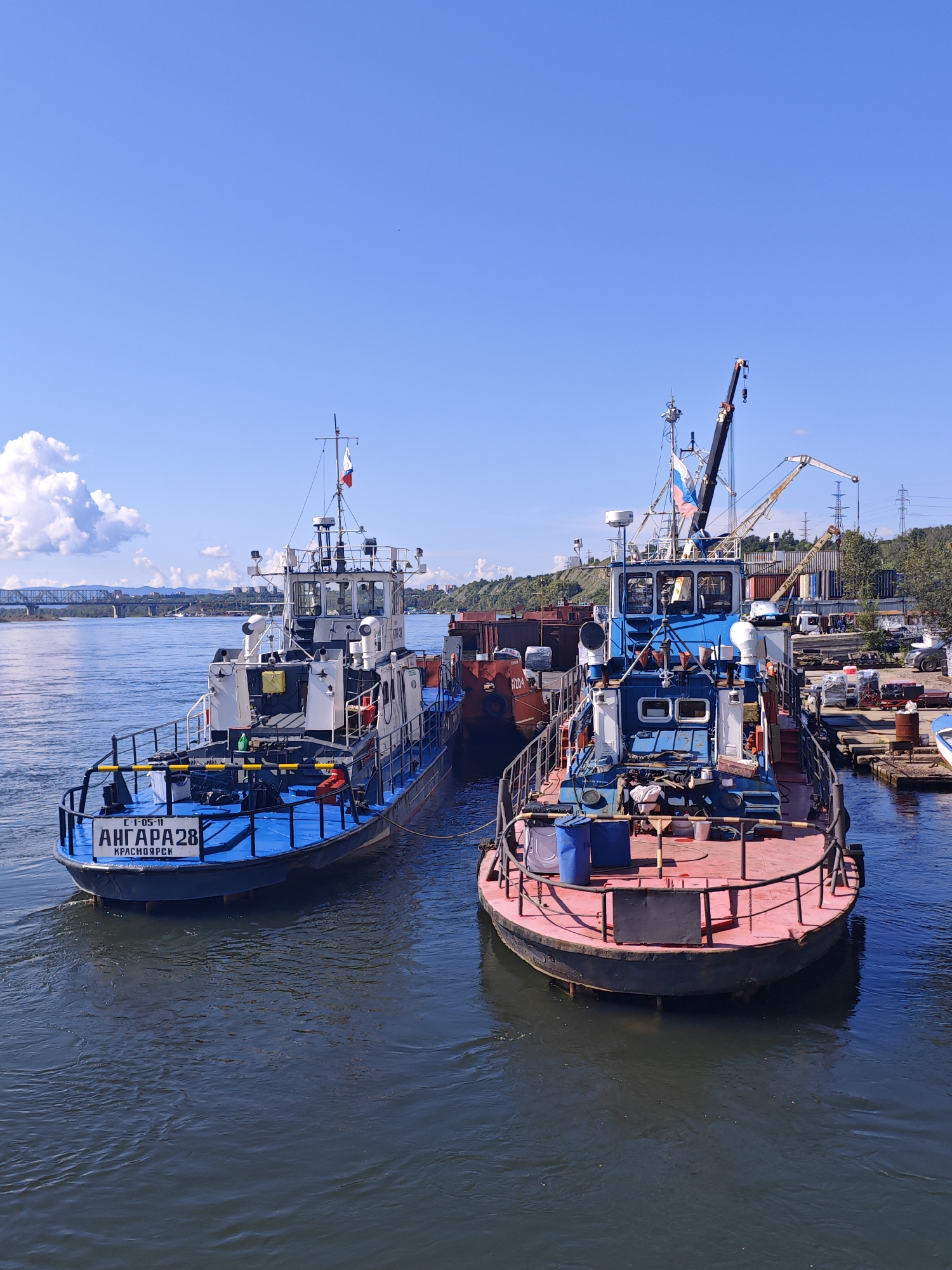 Tugboats docked and ducks wading on the Yenisei River, Krasnoyarsk