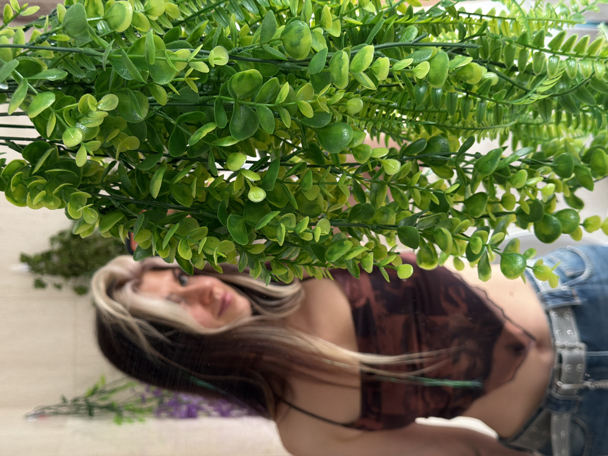 Person observed amid floral displays in Budva indoor setting