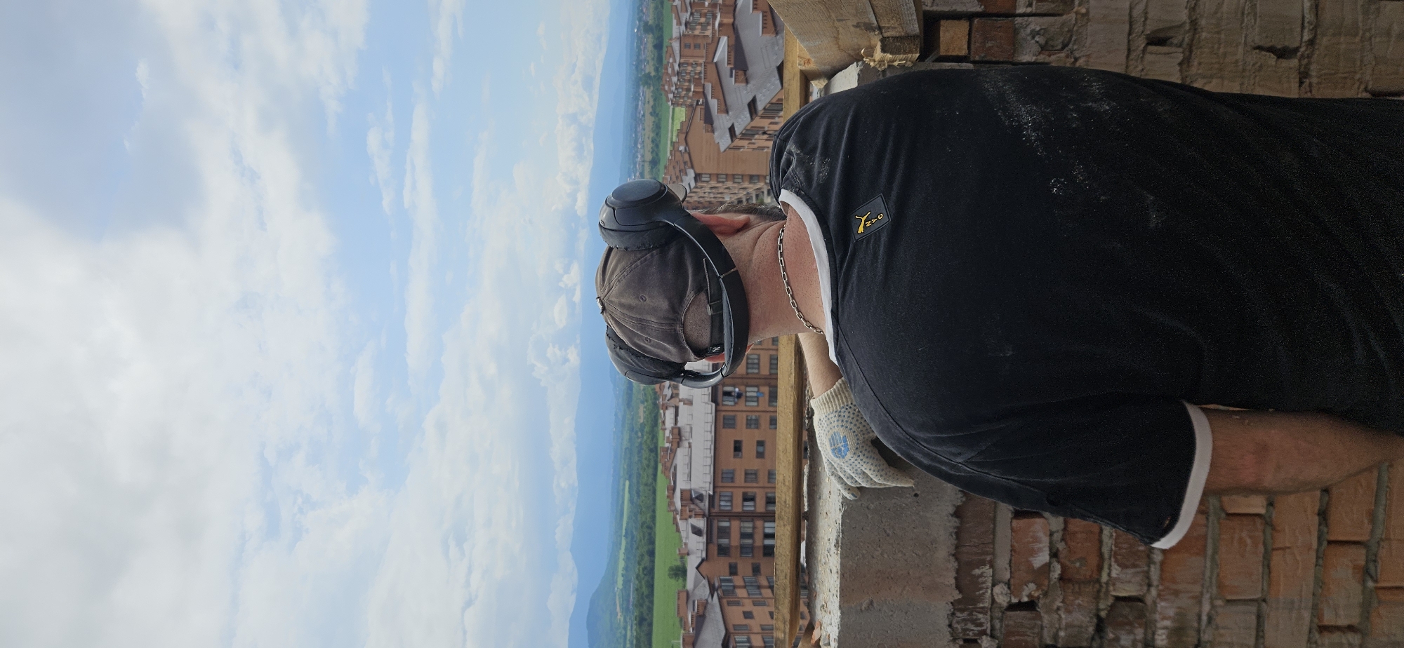 Construction site tour with cranes, skyline views, and a sleeping husky