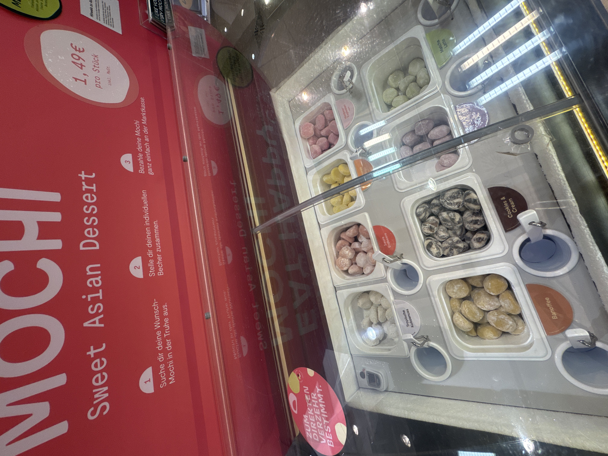 Shopper documents mochi and chocolate displays in Trier store