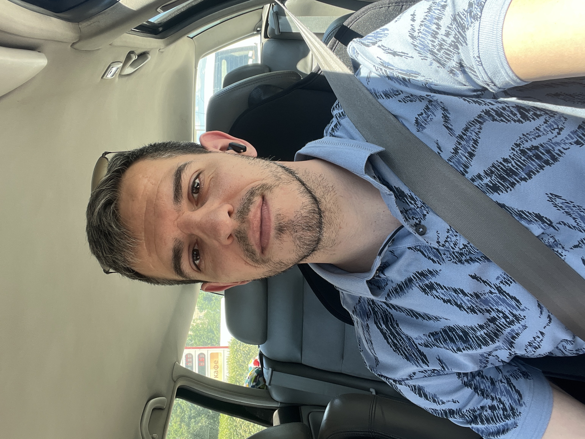 Driver in patterned shirt behind the wheel in Sofia