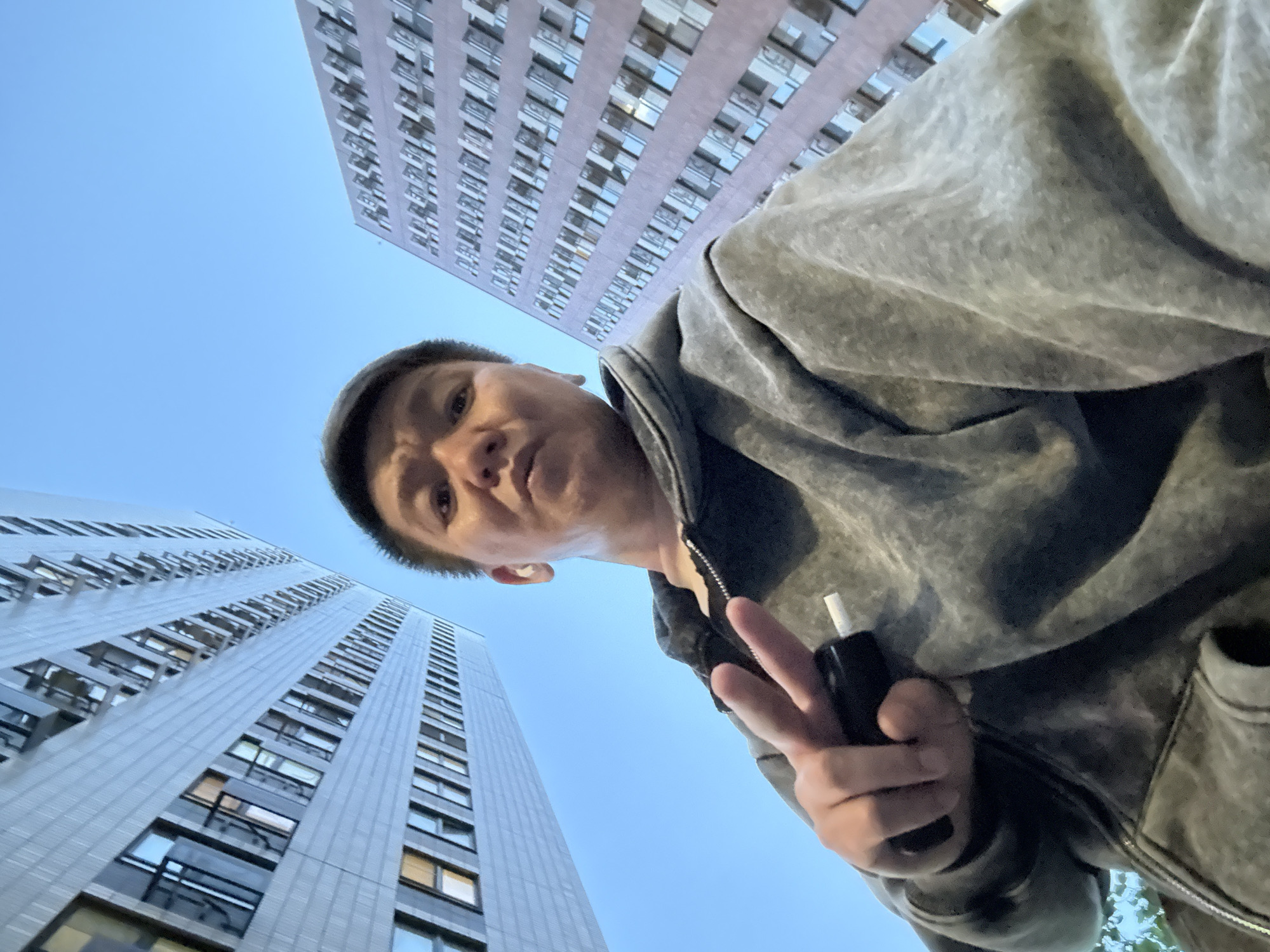Man takes selfies against Moscow skyline making peace signs