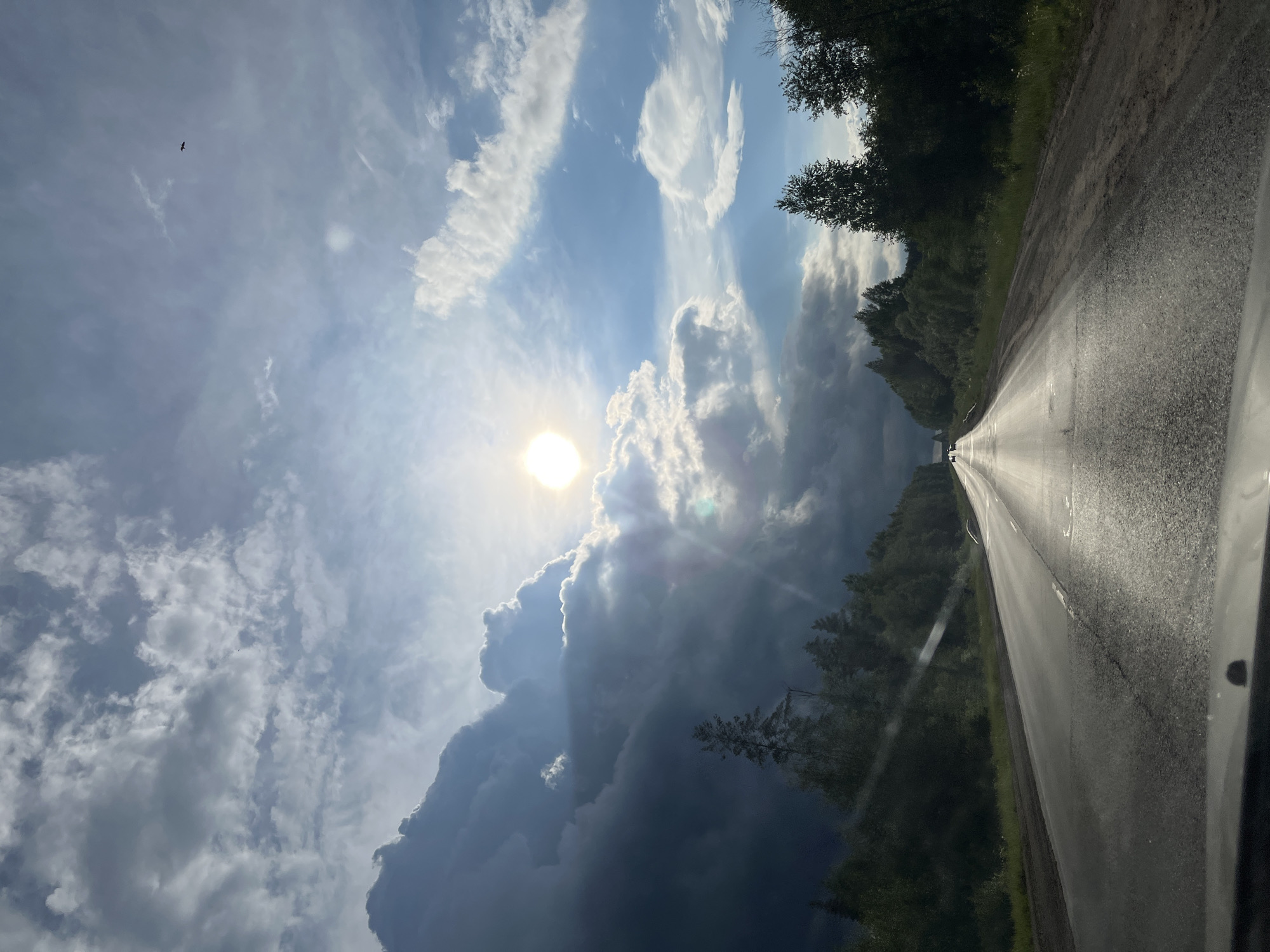 Storm clouds gather over rural road in Гаревая, Russia