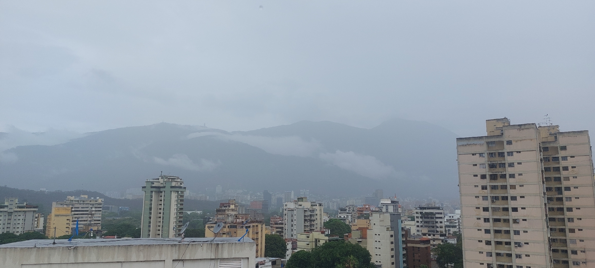 Overcast Caracas cityscape and amusement park observed from above