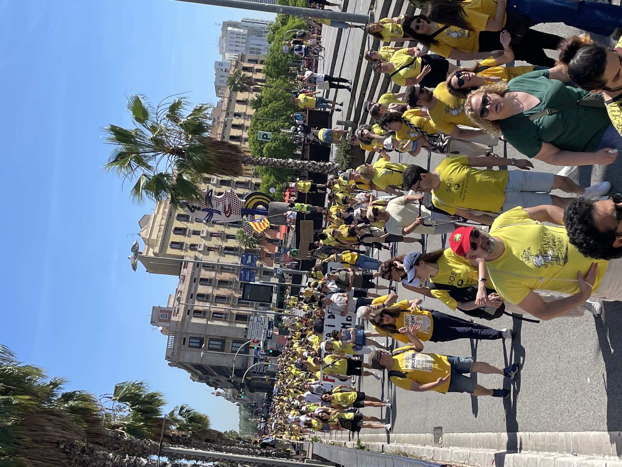 Yellow-shirted demonstrators march through Barcelona streets carrying flags
