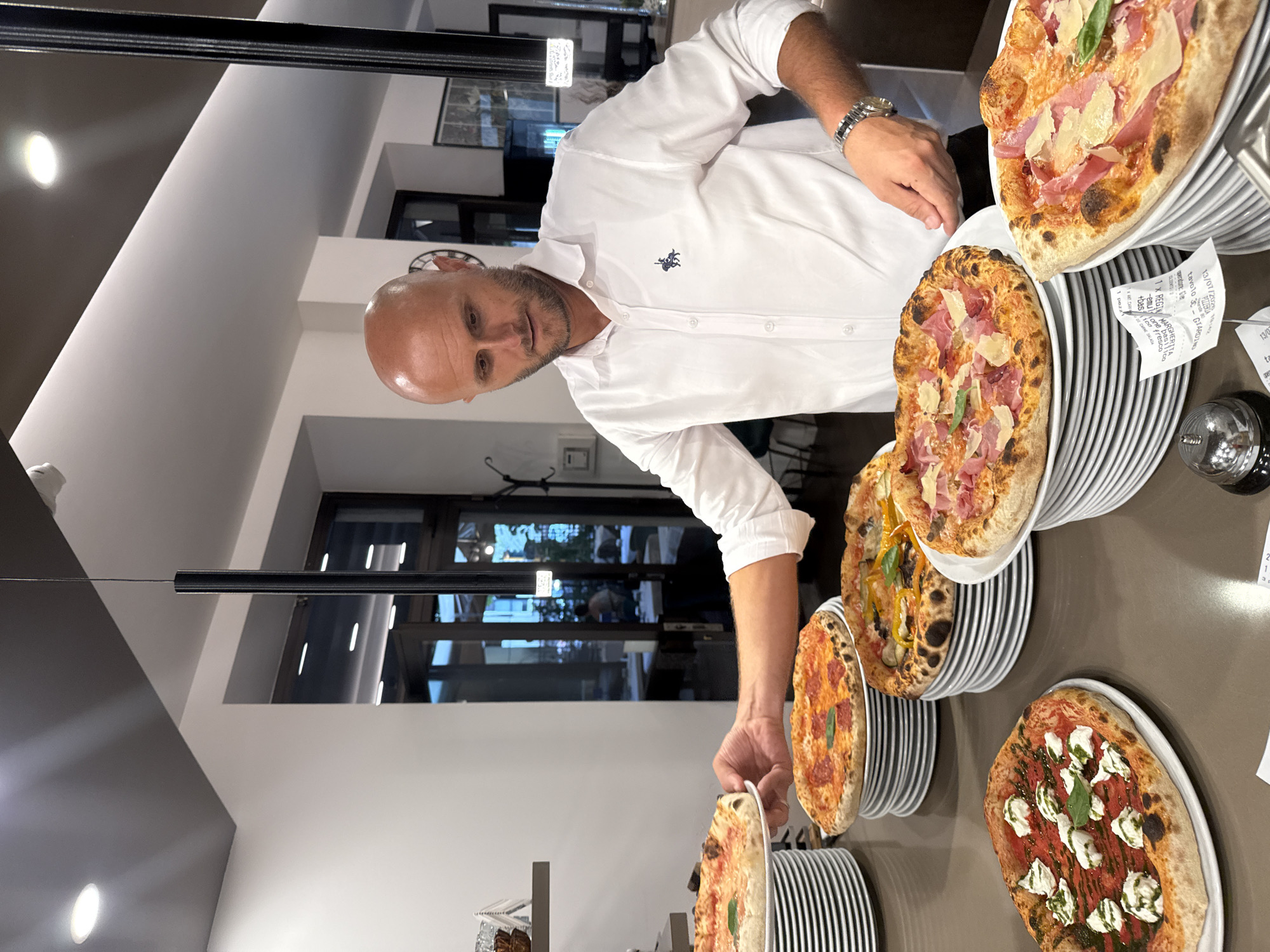Neapolitan pizzas being prepped at a Trento pizzeria