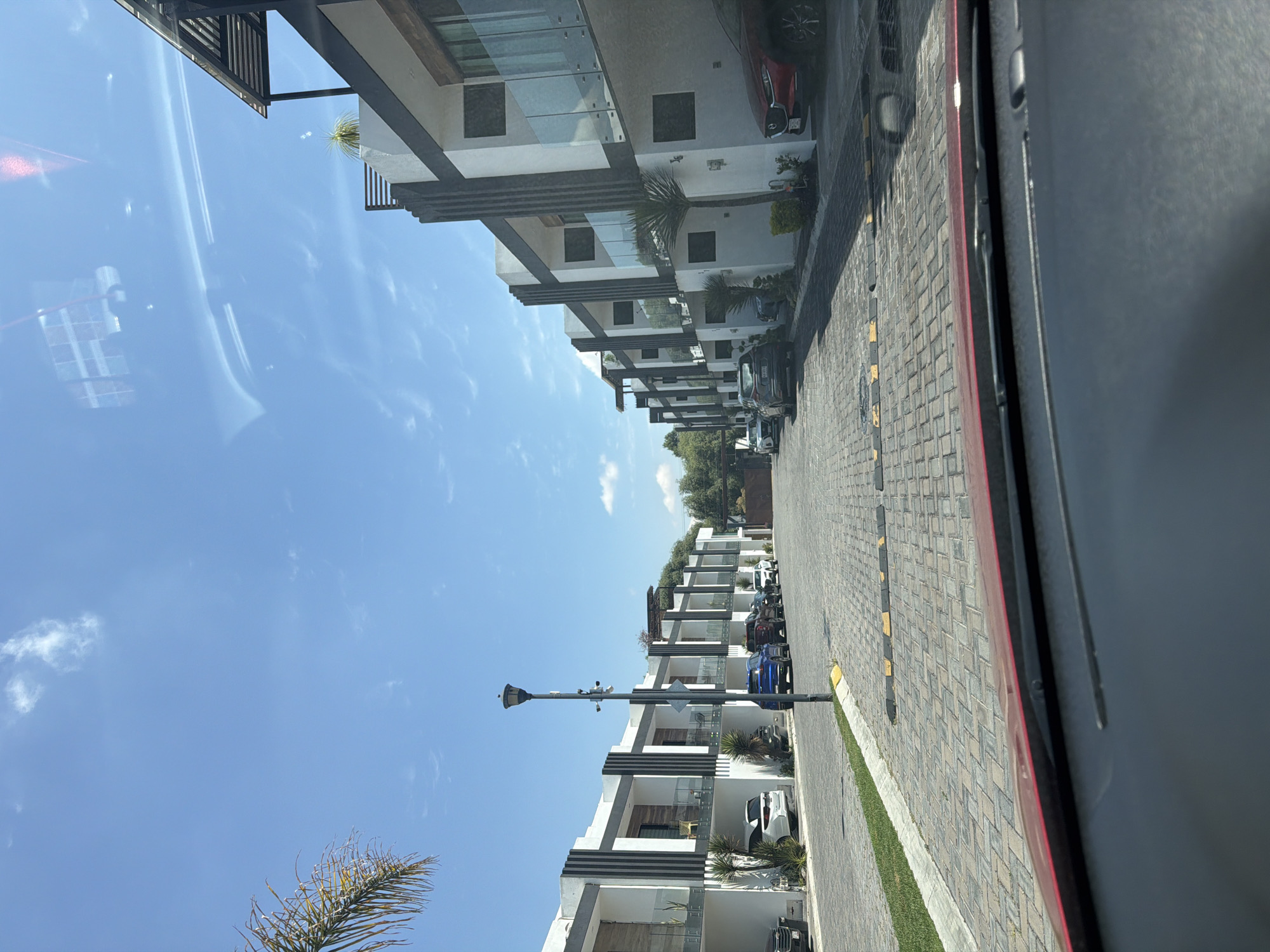 Modern townhouses line residential street in Cholula, Mexico