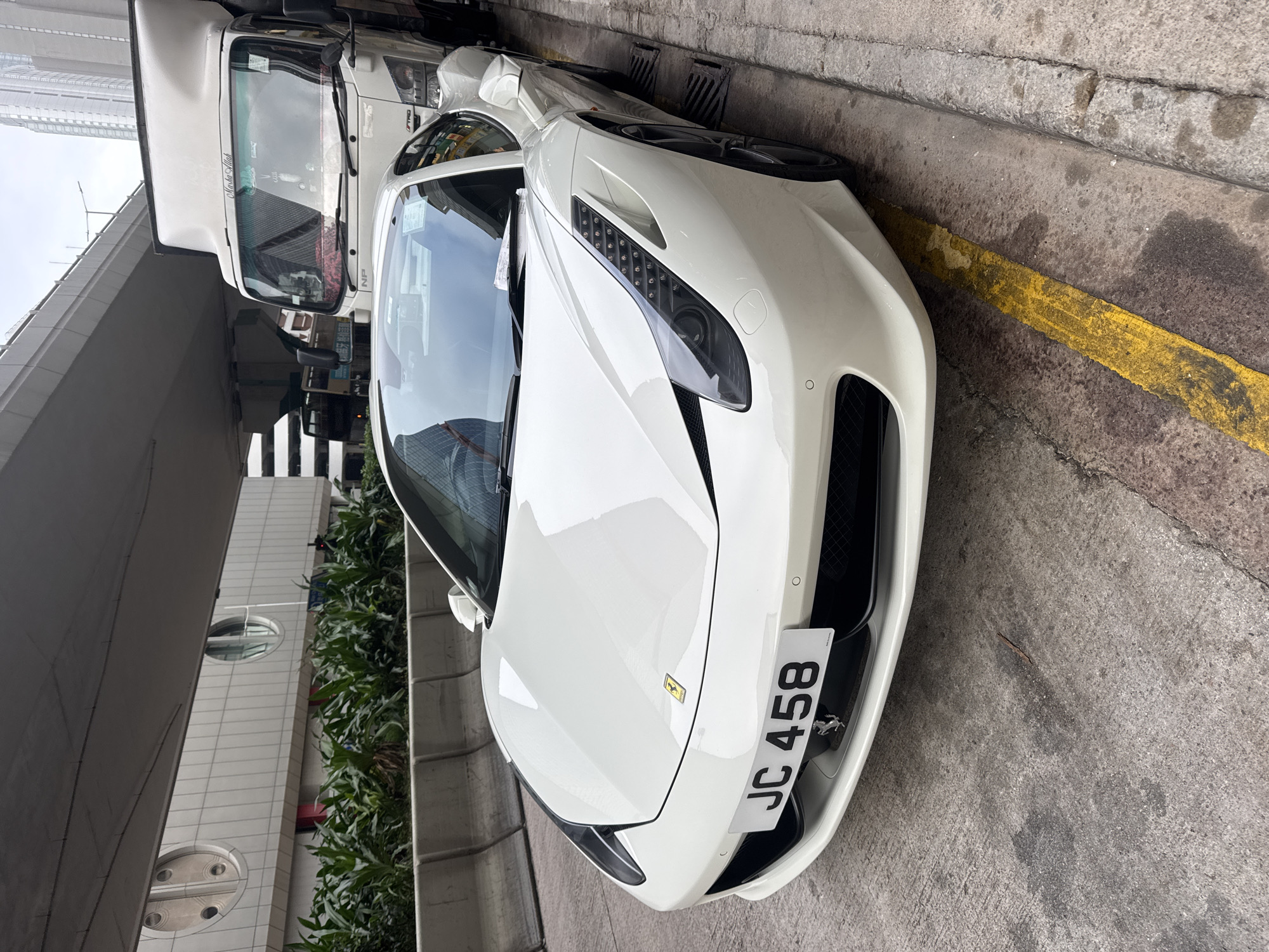 Morning street scenes captured across Hong Kong include Ferrari, tram