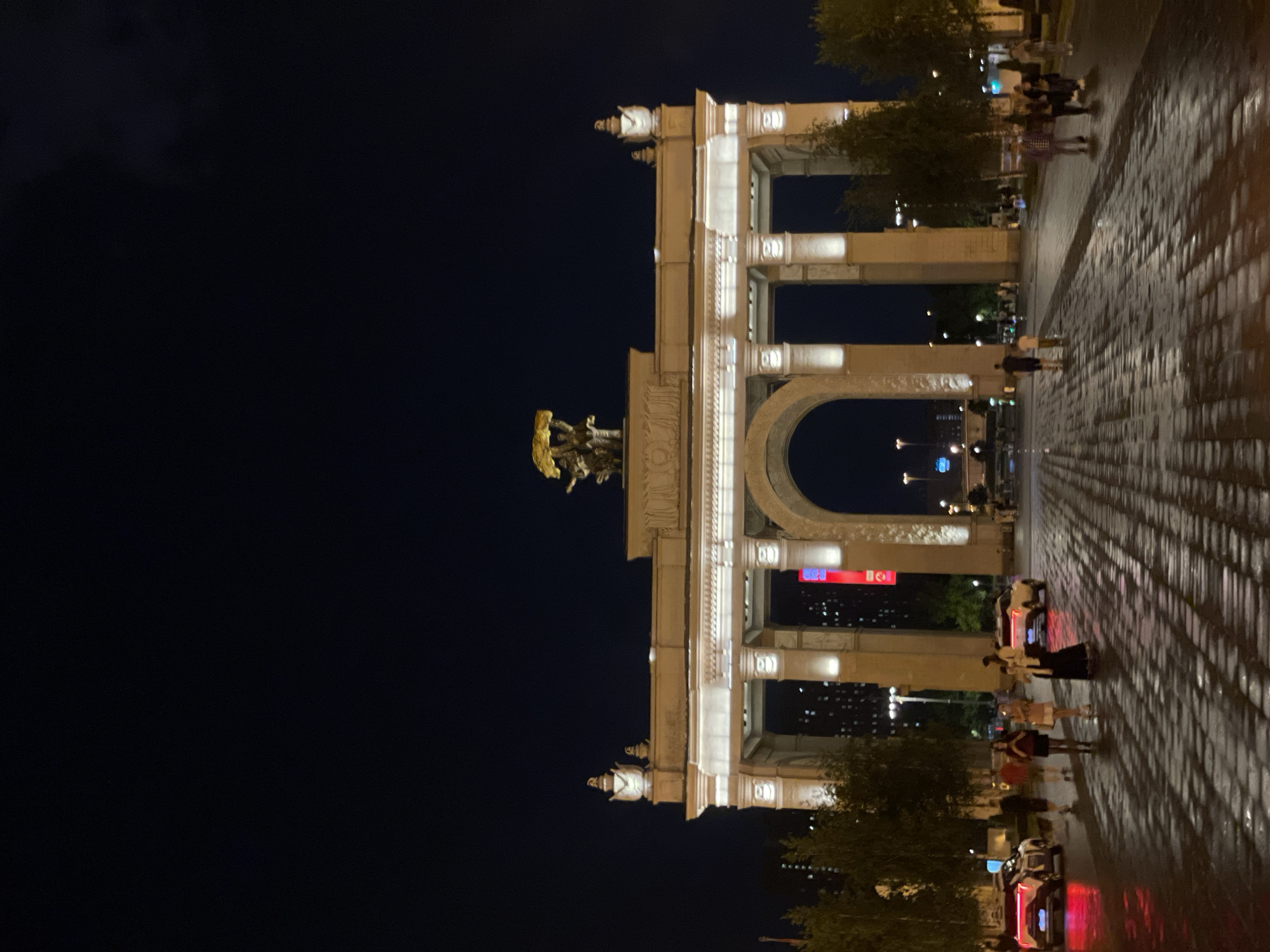 Moscow's Triumph Arch illuminated during evening hours