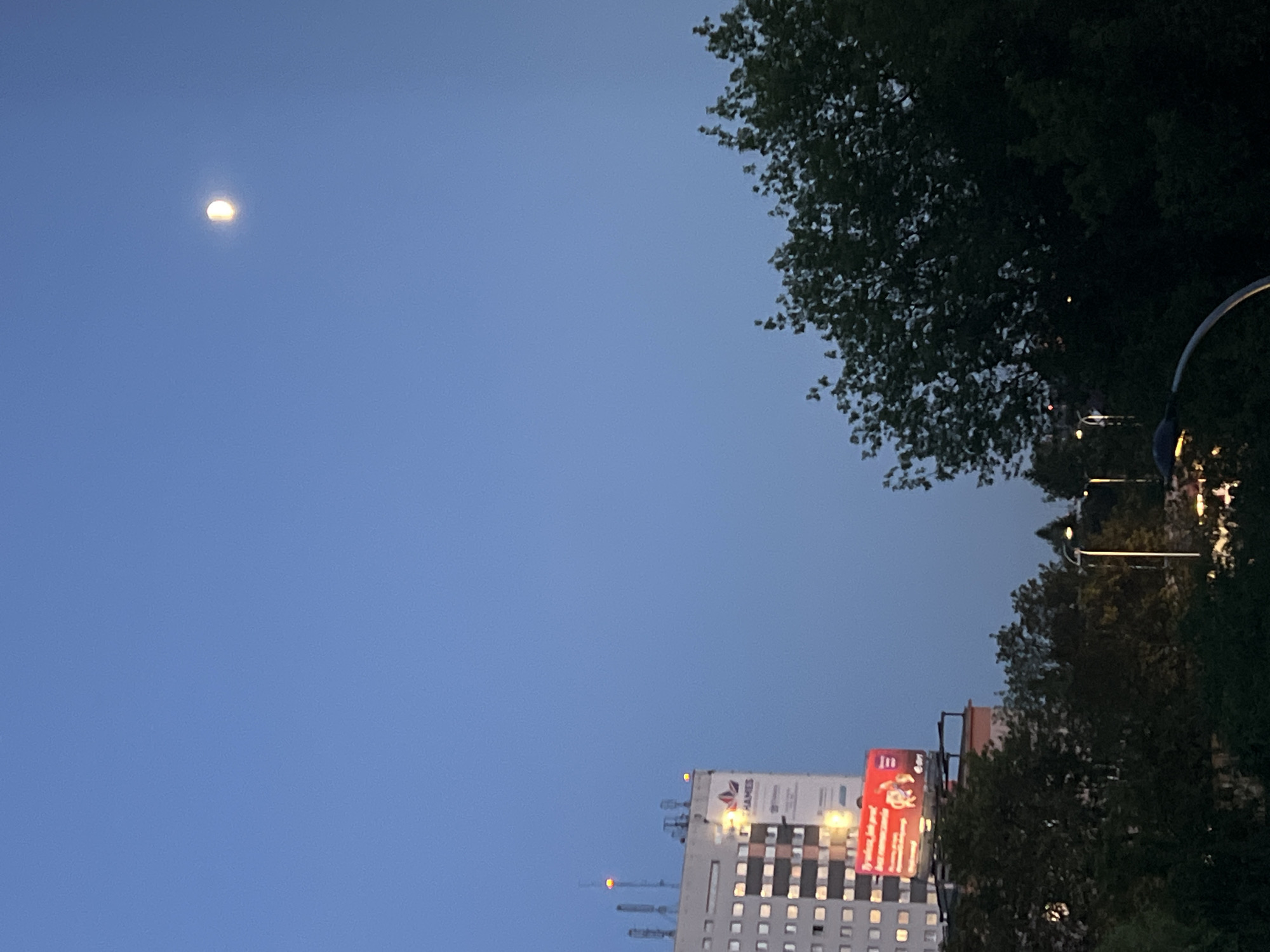 Crescent moon over Warsaw on a June evening