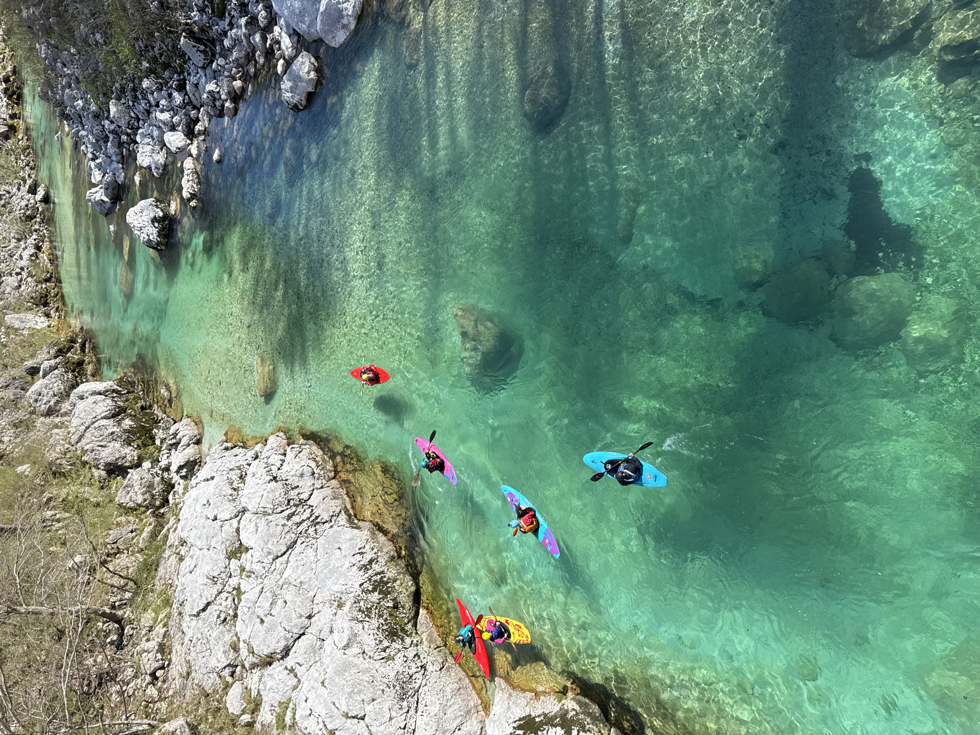 Kayakers navigate Soča River waters near Kobarid, Slovenia
