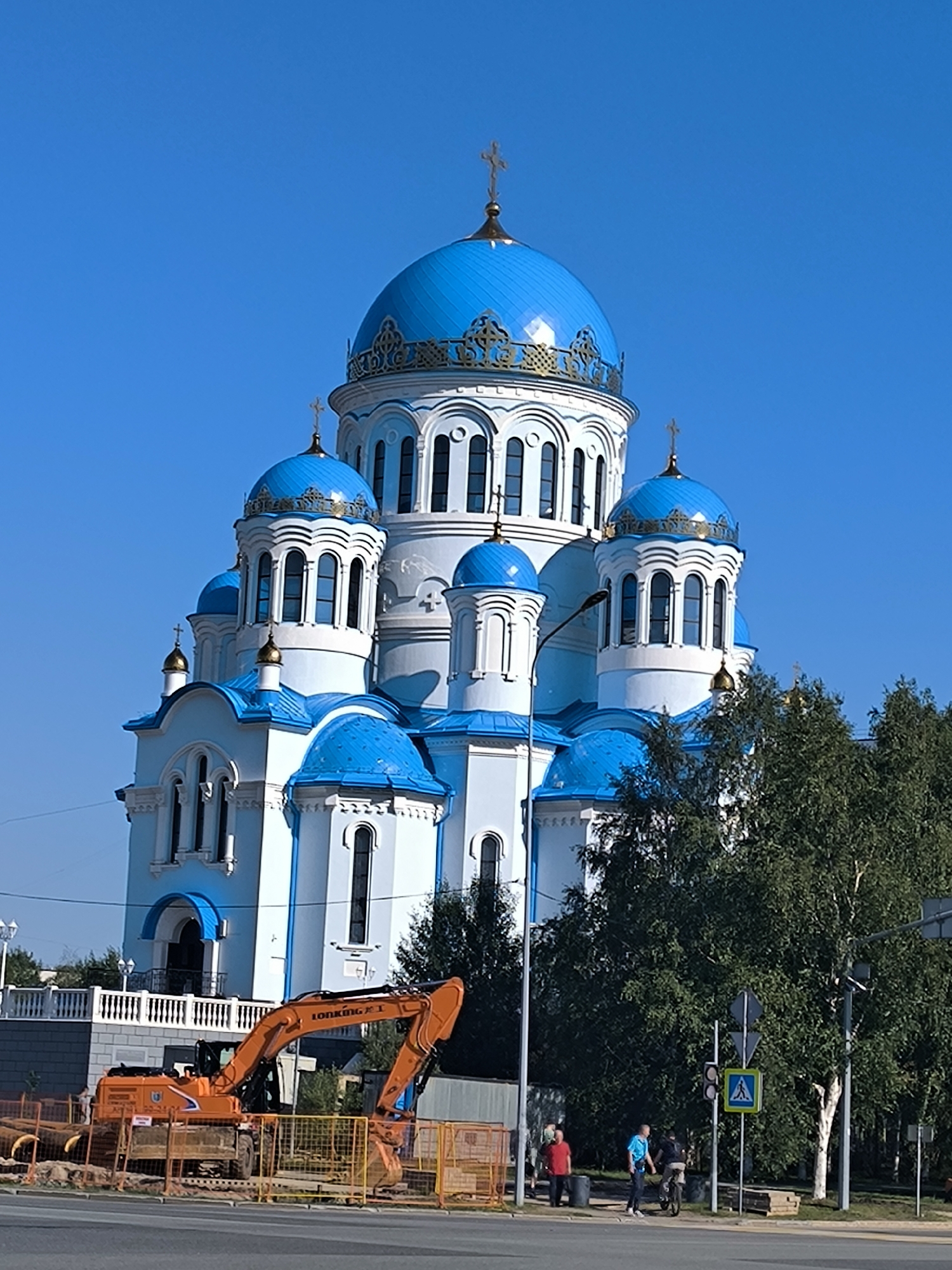 Orthodox church gleams under blue skies in Surgut, Siberia