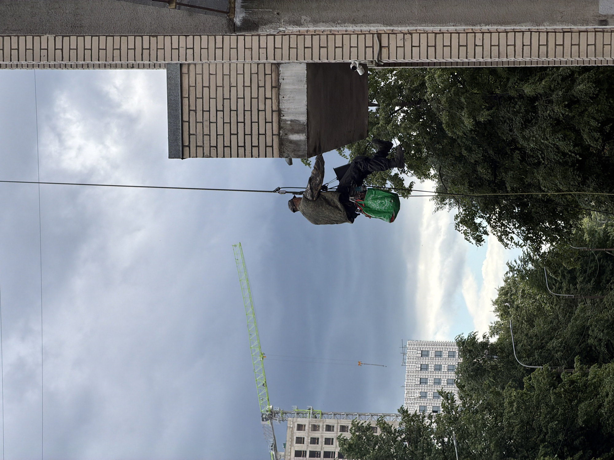 Rappelling down Saint Petersburg apartment building during morning rain