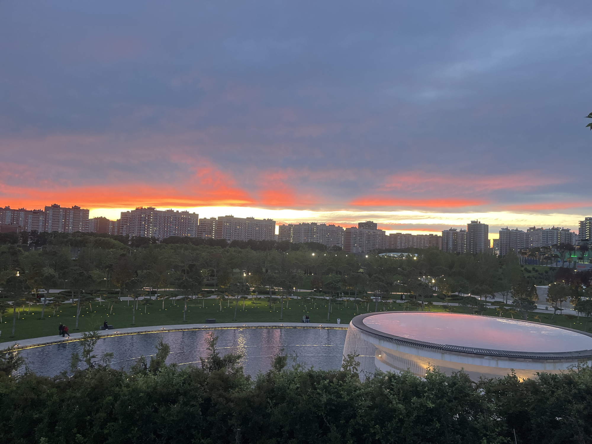 Evening stroll through illuminated Krasnodar park captures sunset gardens