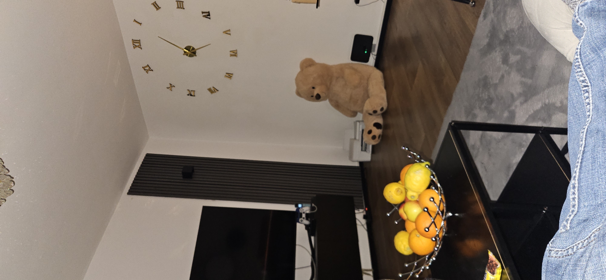 Interior scene captured in Gütersloh showing clock, teddy bear
