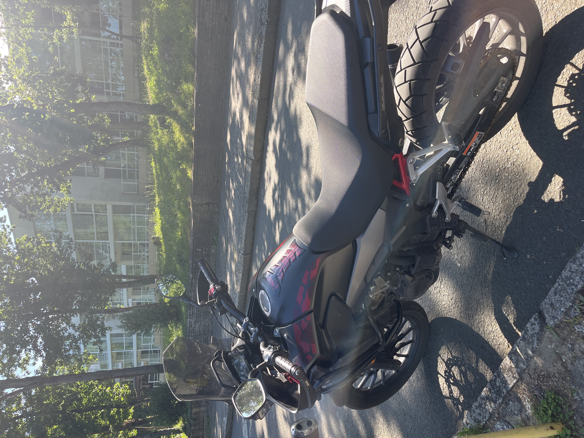 Motorcycle and outdoor dining scenes documented during sunny afternoon
