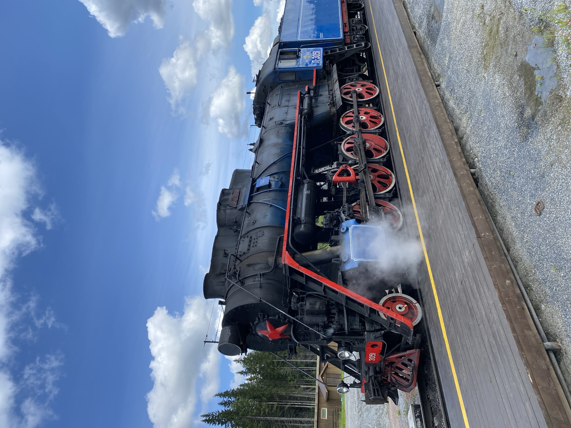 Vintage steam train and marble quarry cliffs at Ruskeala Mountain Park