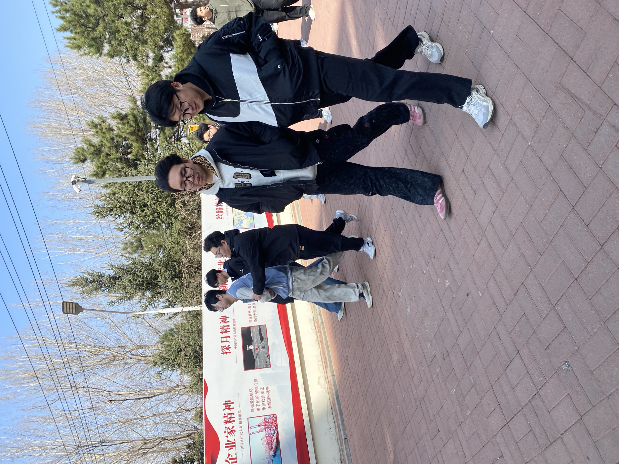Group poses for photo near sign in Zhongtun