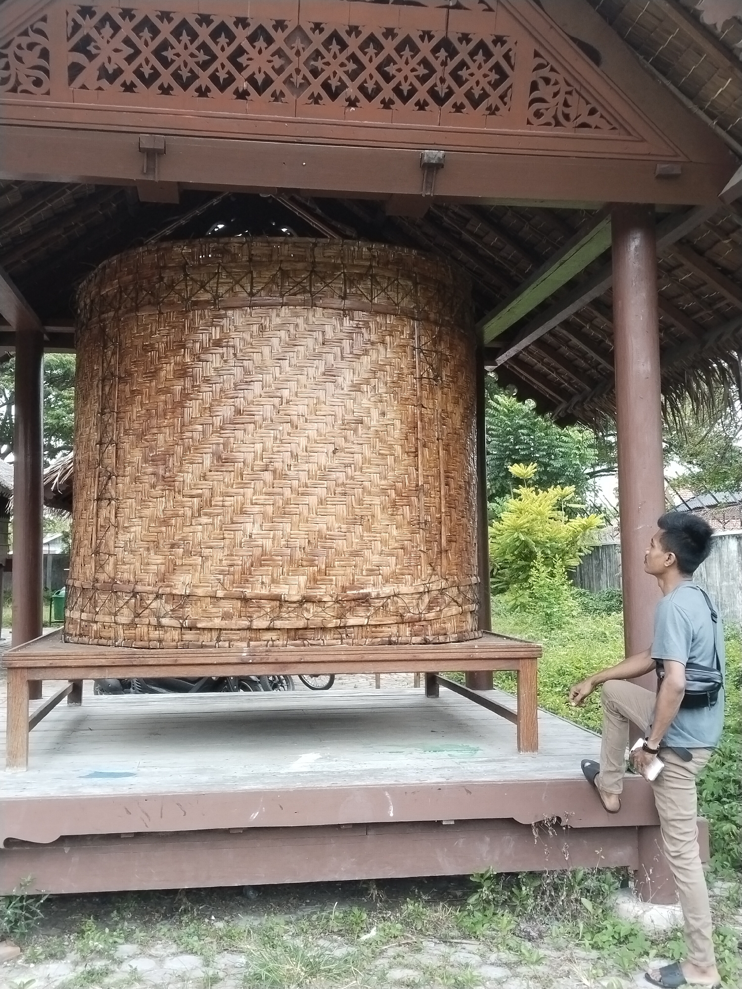 Museum visitor explores traditional Indonesian cultural exhibits in Lhokseumawe