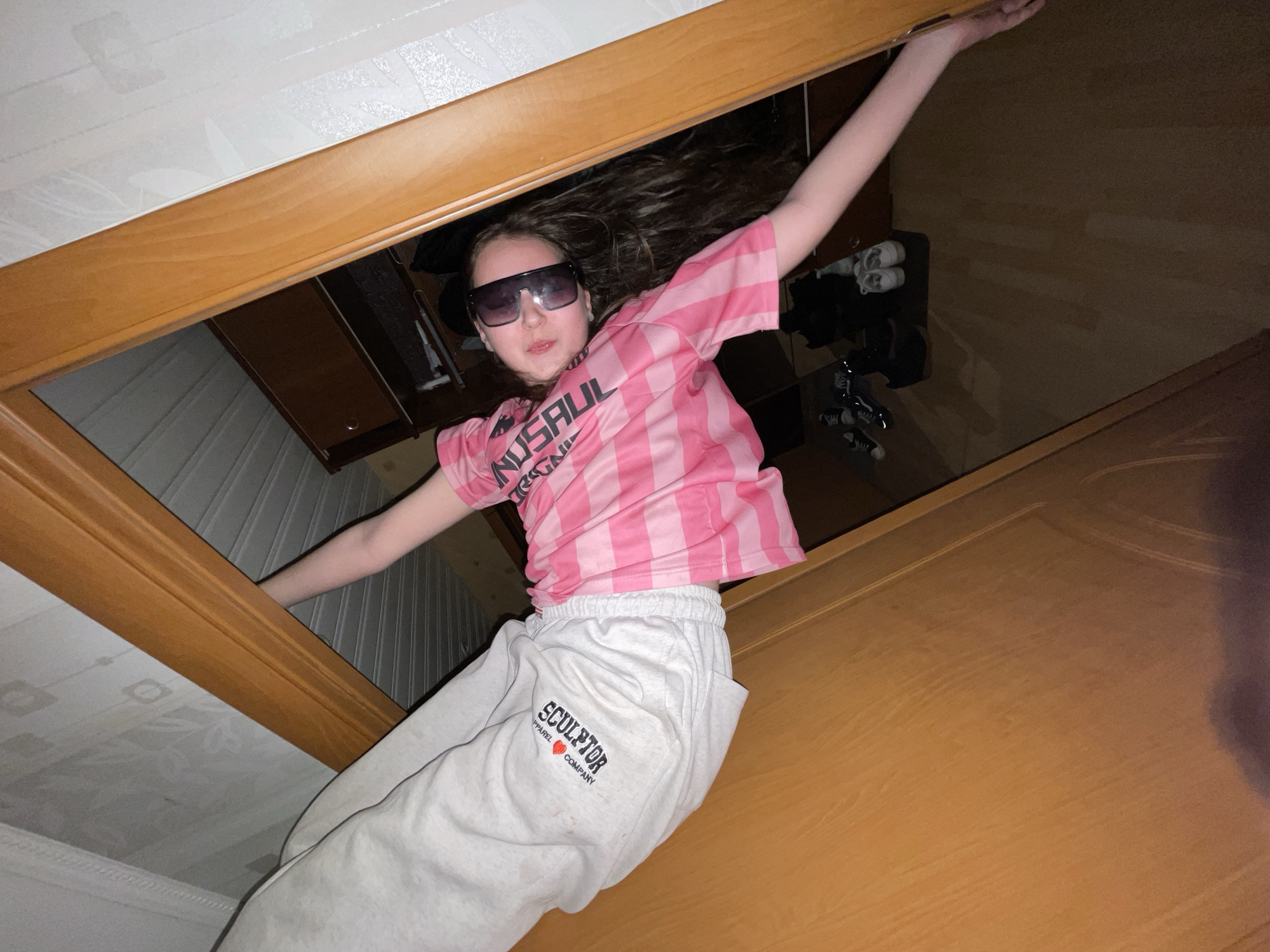 Young person photographed through wooden frame in Novoe Devyatkino