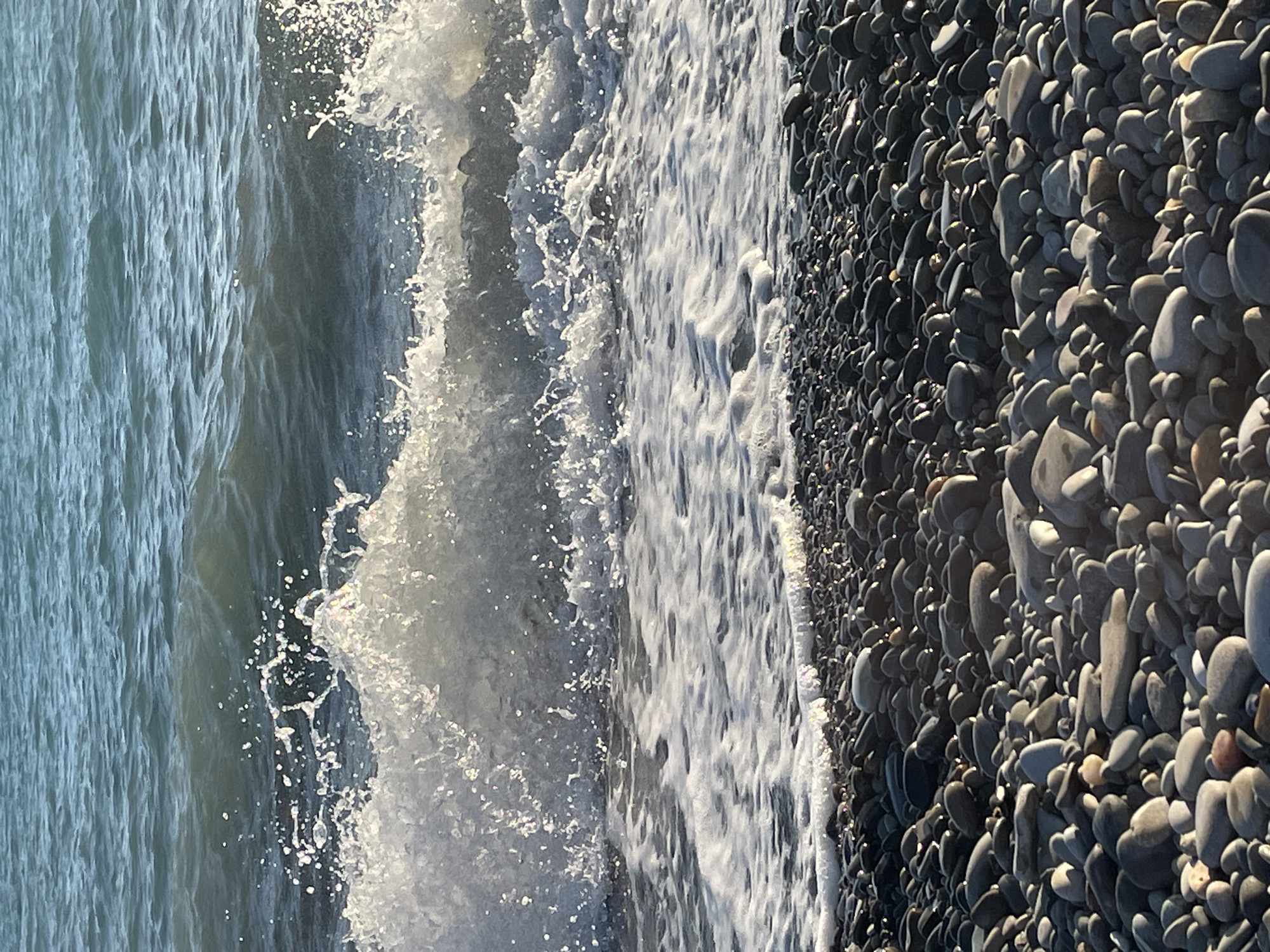 Lazy afternoon on a pebble beach with coastal views