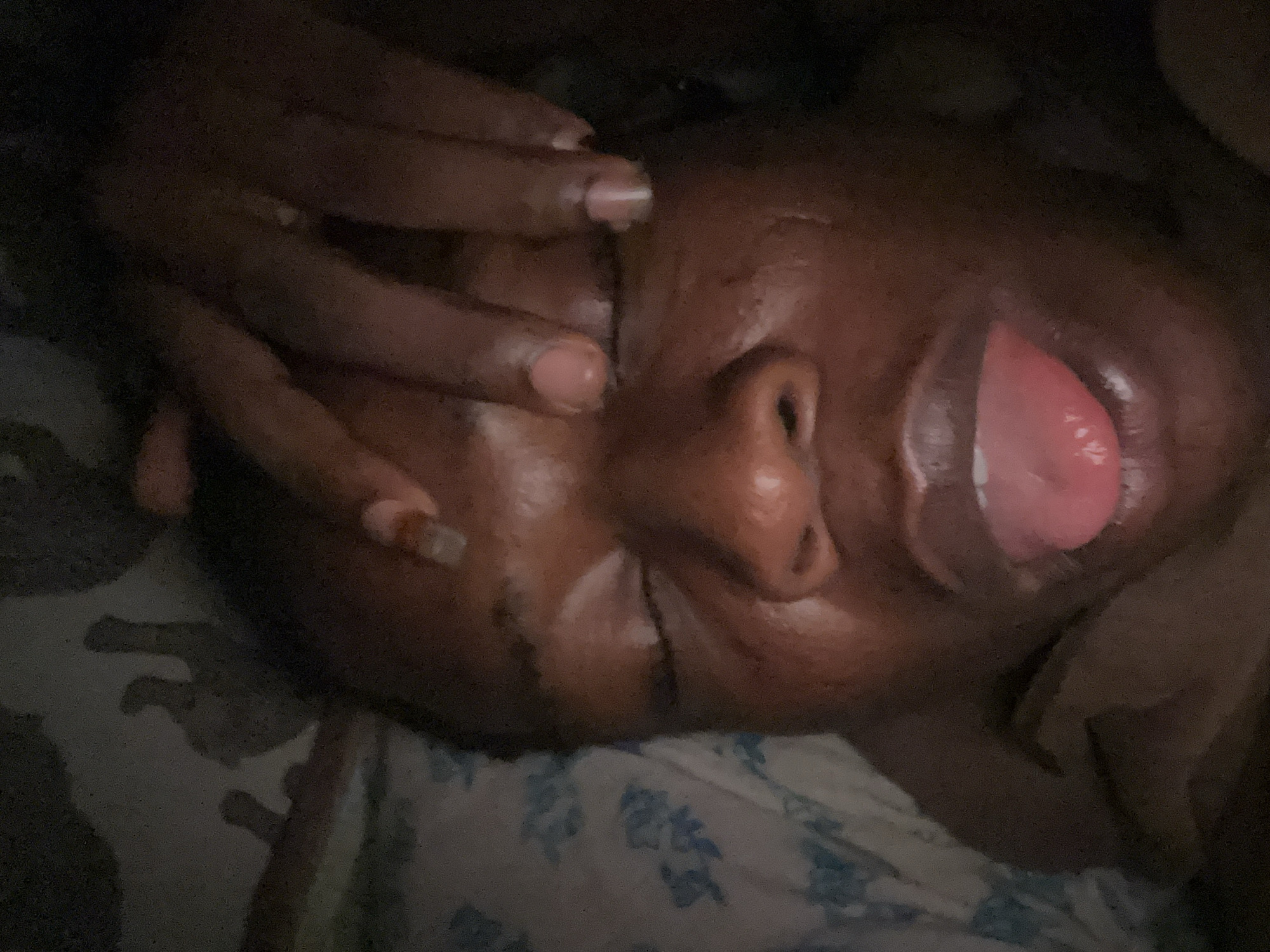 Person photographed in bed making facial expressions