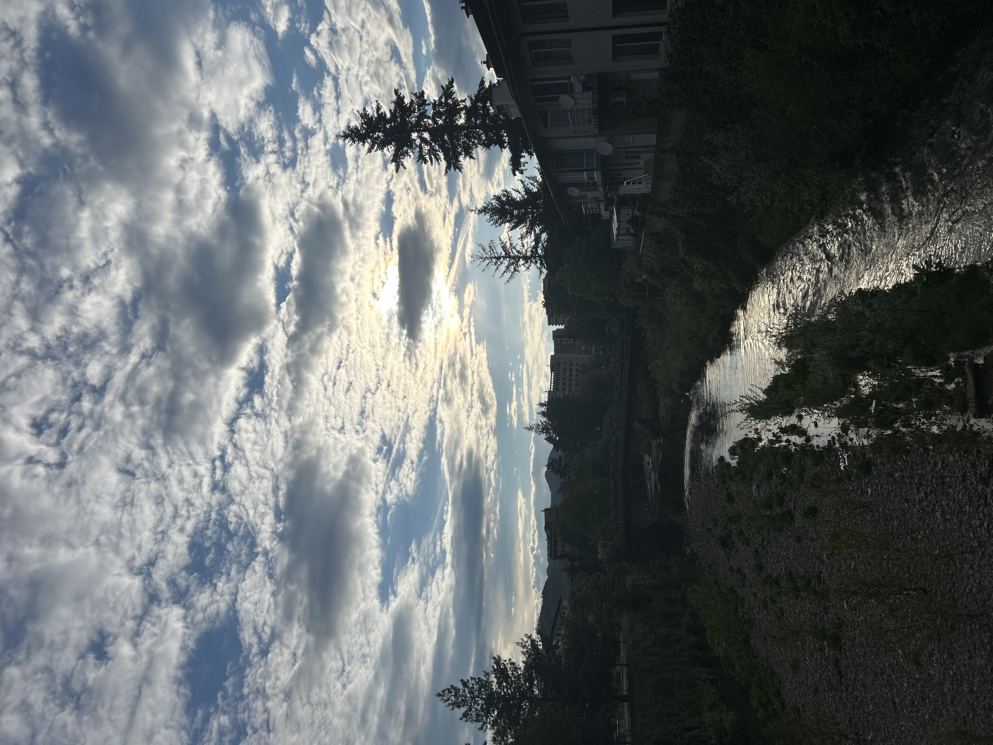 Sunlit stream flows through Zlatograd, Bulgaria under cloudy skies